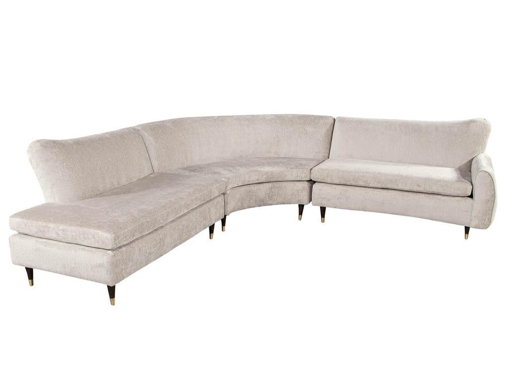 Restored Vintage Mid-Century Modern Sectional Sofa Set. Featuring original iconic mid-century modern curved design. Masterfully restored with new luxurious upholstery material in beige color tone. This 3-piece sofa set is completed with sleek black