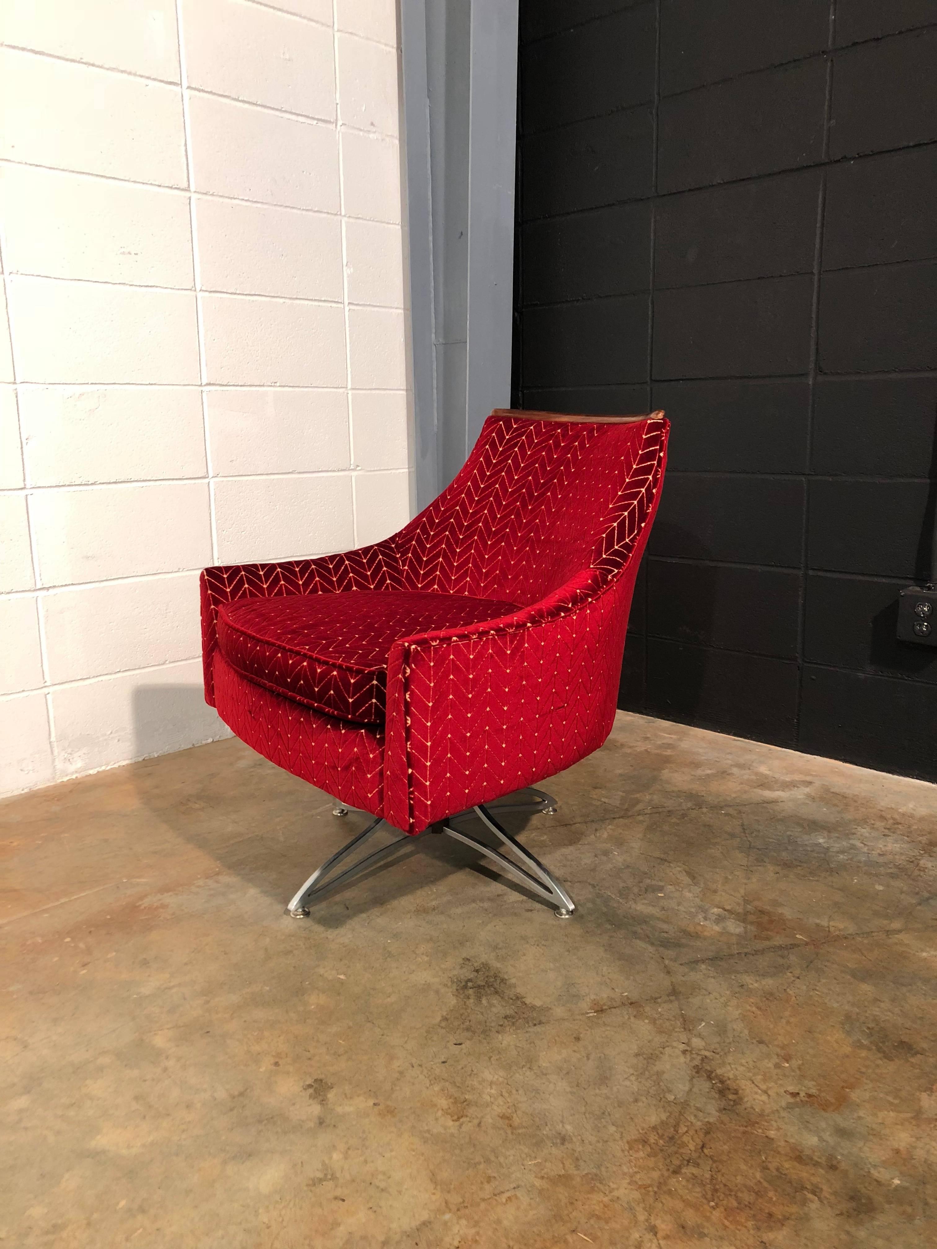 Unique Mid-Century Modern swivel chair.
Very cool shape on this one. Check out the pointed back

This chair has been completely restored including new foam, new textured red velvet upholstery, polished base, and refinished walnut trim. The swivel