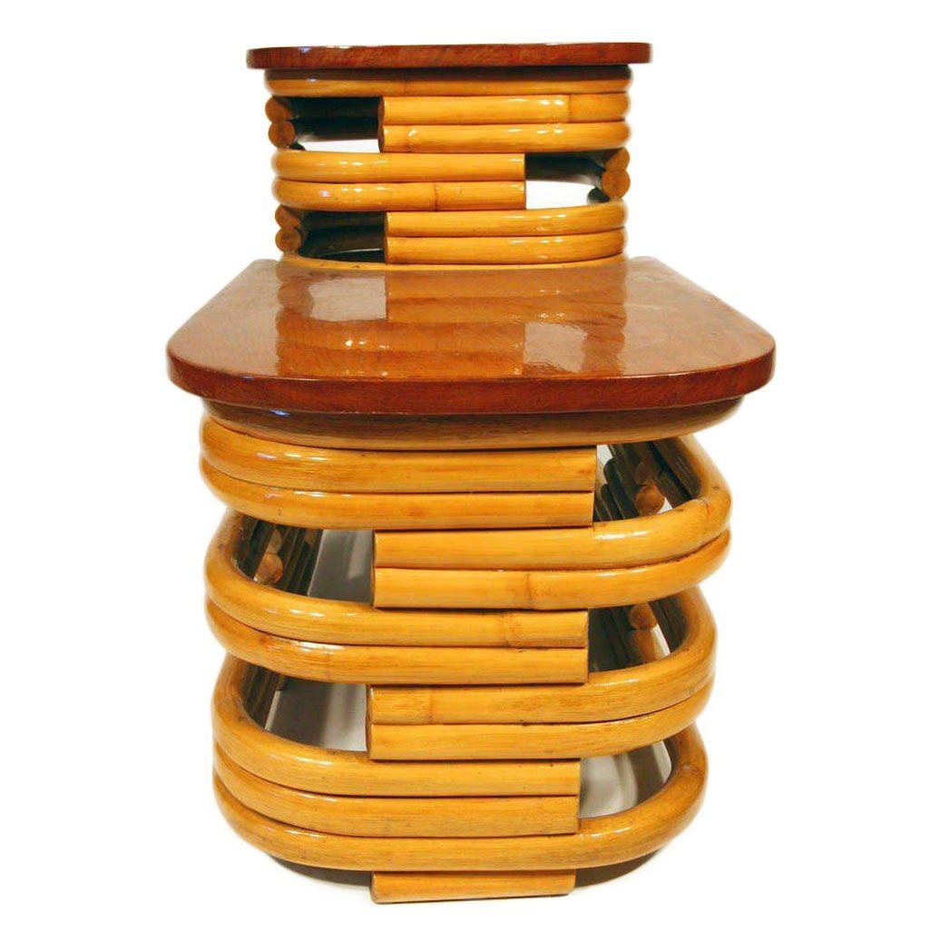 Vintage 1940s two-tier stacked rattan side table with stylized cut-out sides and beautiful mahogany tops on both tiers. The stunning table is designed in the manner of Paul Frankl.

Additional quantities available.

(Also available matching chairs,