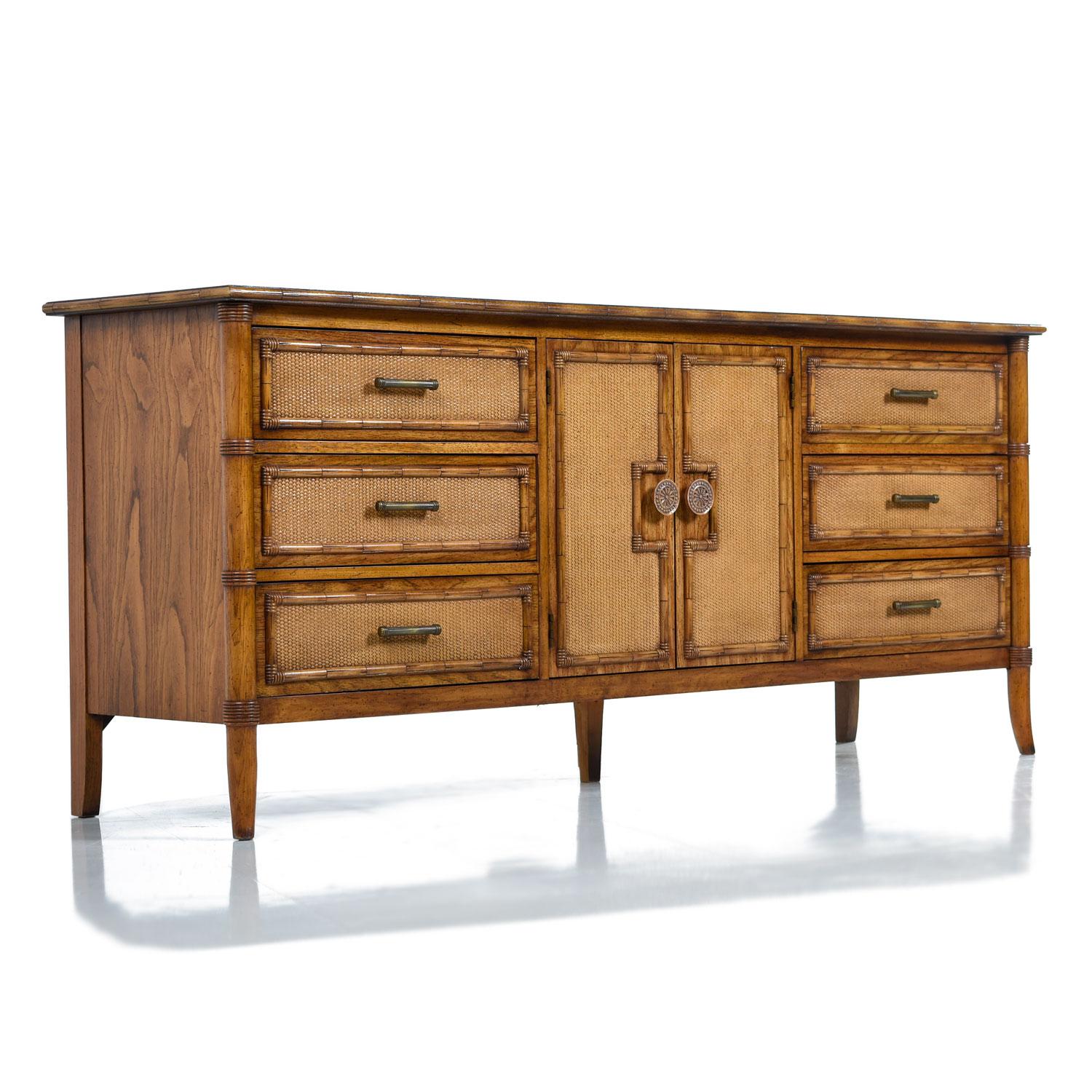 Breathtaking Mediterranean style Hollywood Regency dresser / credenza. Made by Thomasville Furniture Company, circa 1970s. Lots of flare packed into the this restored vintage Eastern inspired dresser. The richly grained golden fly-spec oak wood is
