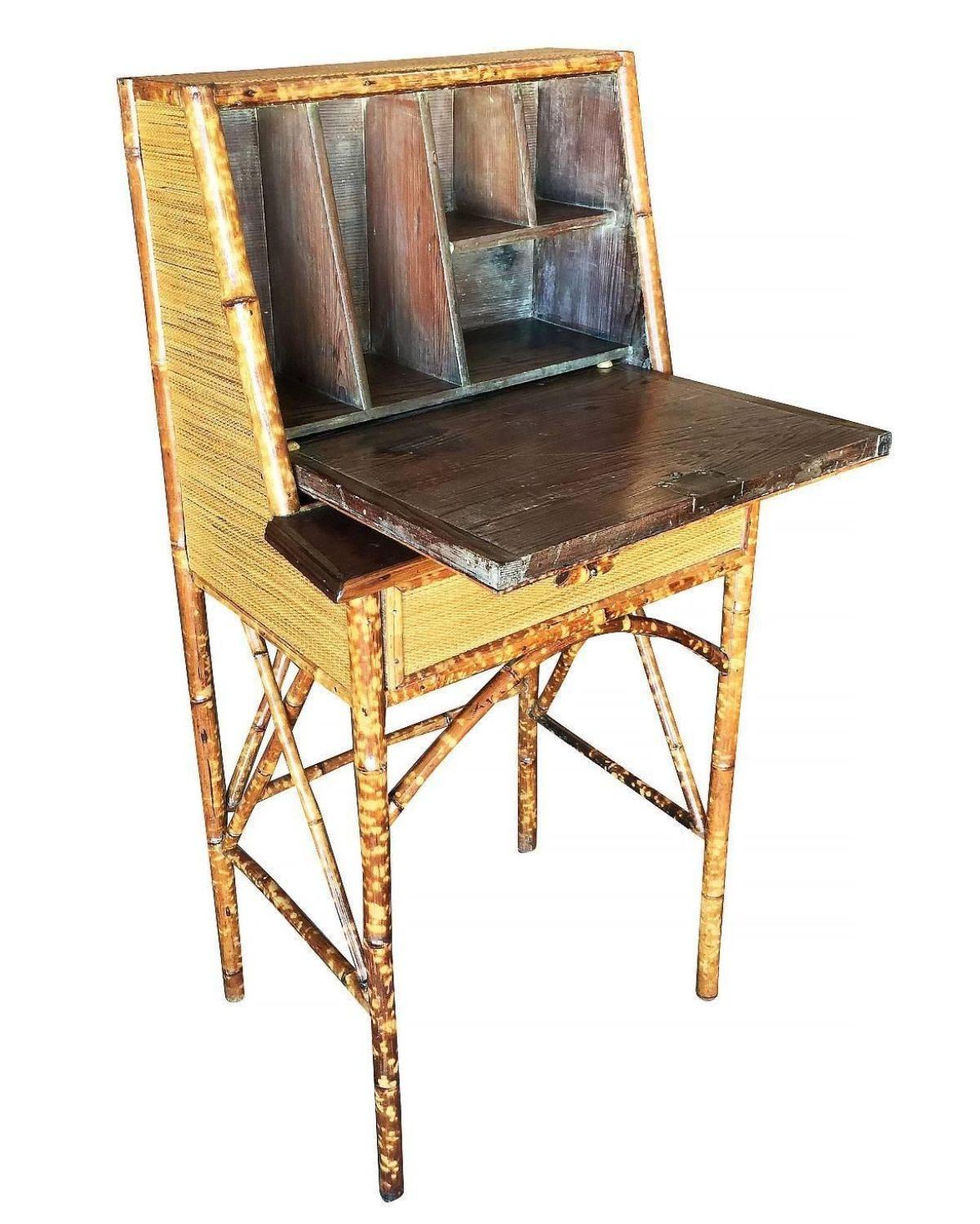 Tiger bamboo secretary desk with handwoven rice mat coverings, center drawer and flip down the front opening to five smaller shelves for papers and stationery.

Restored to new for you.

All rattan, bamboo and wicker furniture has been painstakingly