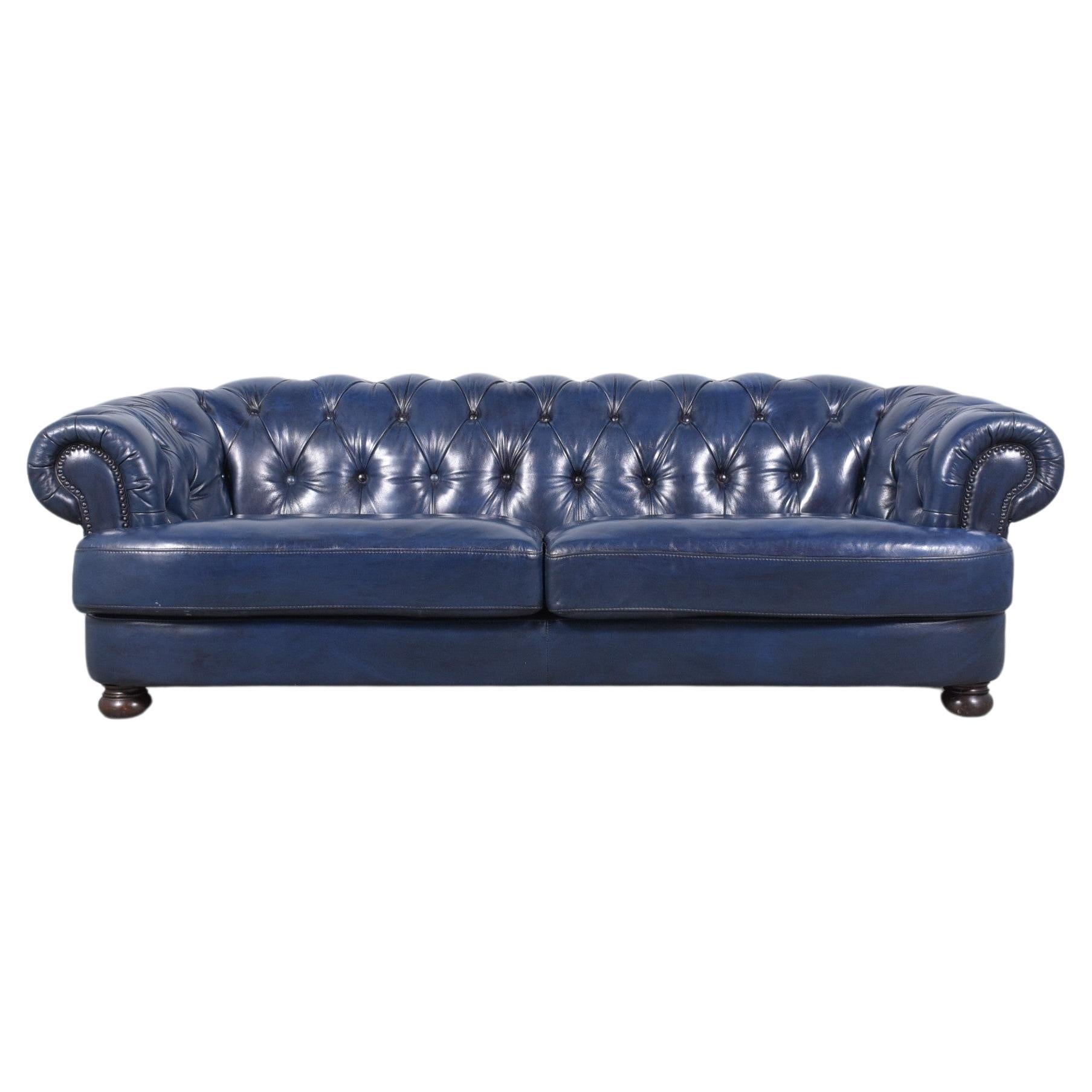 Discover the vintage charm of our restored Chesterfield sofa, a blend of classic and modern styles, perfectly suited for any living space. This 1980s masterpiece features high-quality leather in custom navy blue, meticulously dyed to preserve its
