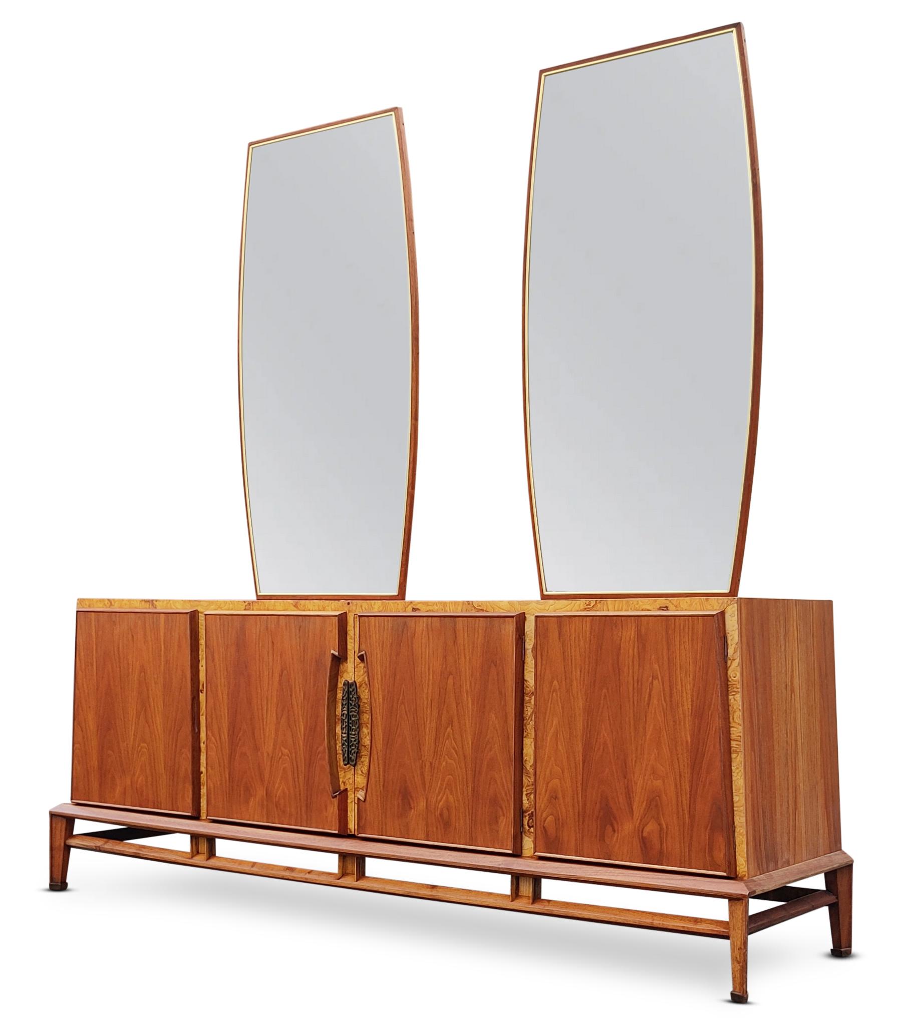 This rare and super sculptural cabinet or dresser was designed in the 1970s by Helen Hobey for Baker. It features a walnut and burlwood construction that is warm and pleasant to the eye. Sides that slope inward to meet the top, and an articulated