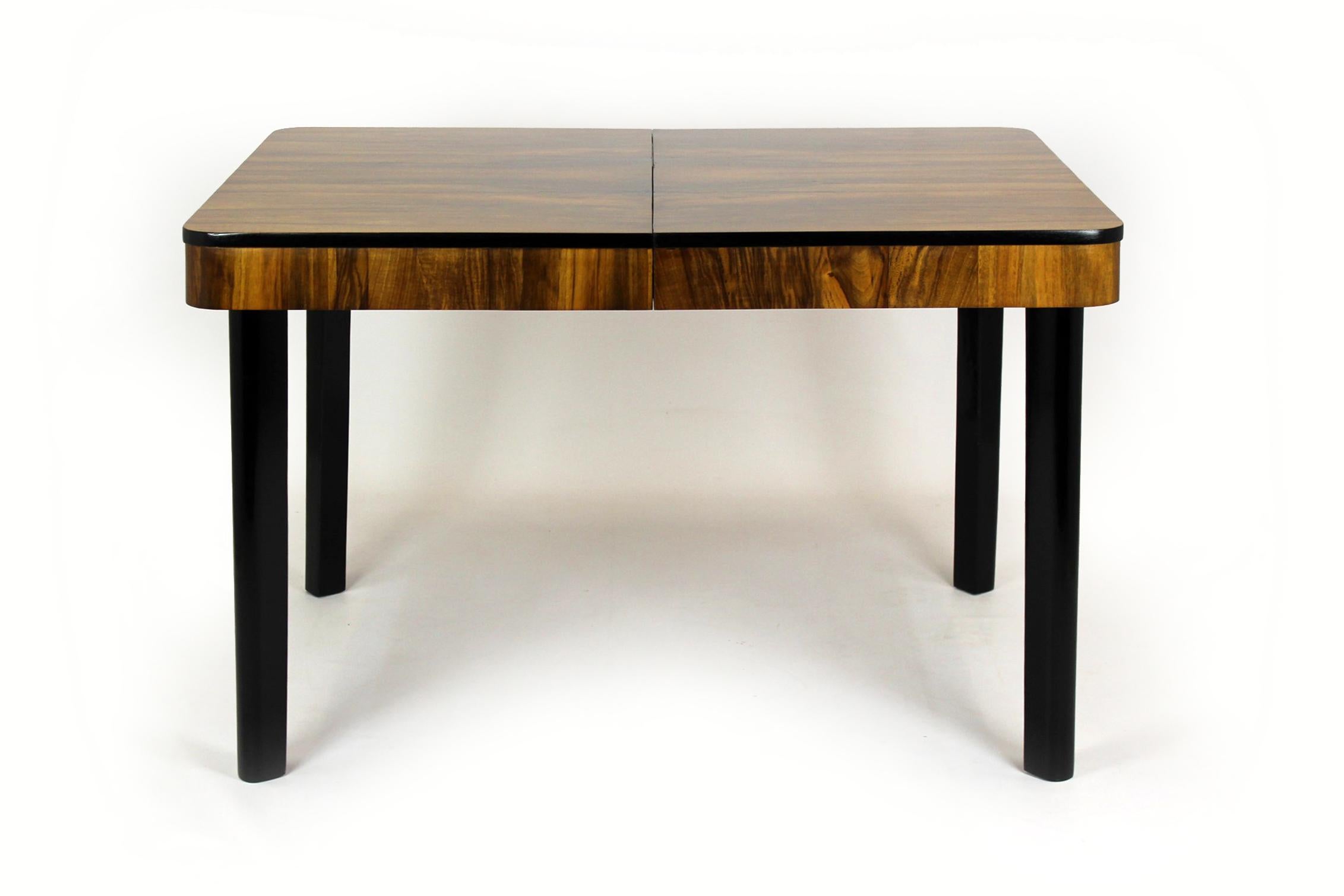 This extendable dining table with a beautifully patterned walnut top was designed by Jindrich Halabala and produced by Drevotvar (Czech Republic) in the 1940s. The table was renovated about 2 years ago, it is still in very good condition, with