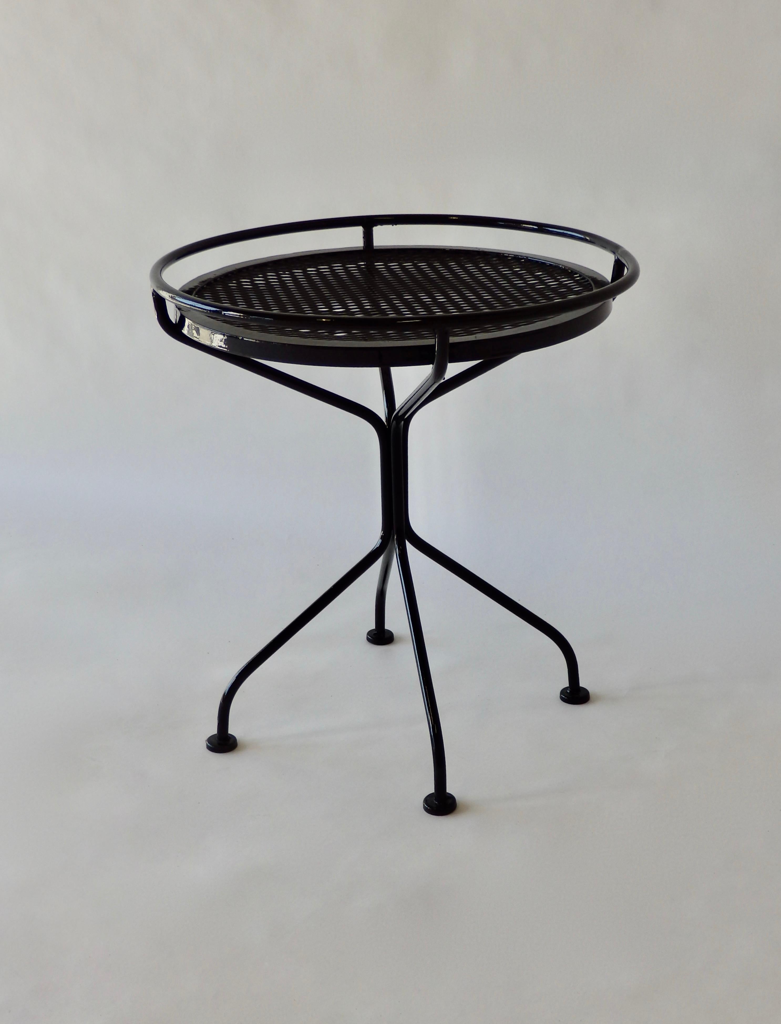 Recently powder-coated in gloss black, this wrought iron and steel circular mesh patio side table would make a sharp edition to your outdoor living space.
 