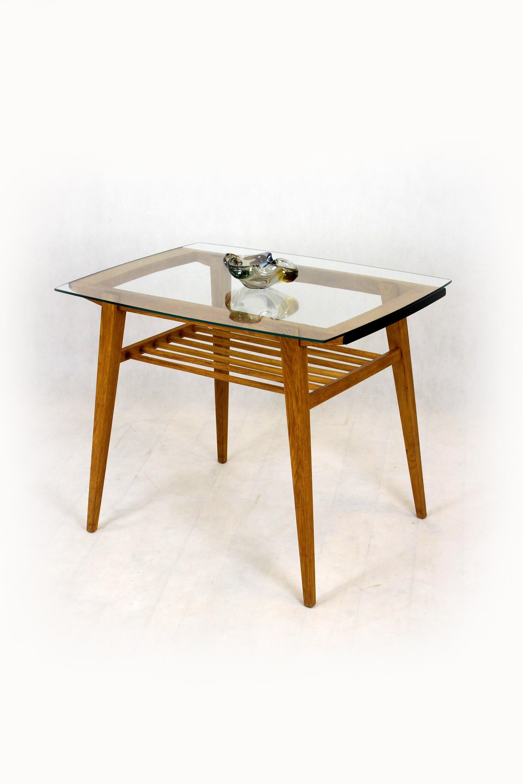 A unique coffee table, a combination of a wooden structure and glass. It was produced by Drevozpracujici Druzstvo in the 1960s in Czechoslovakia.
The table has been completely restored, lacquered in a satin finish. The glass on the table top is