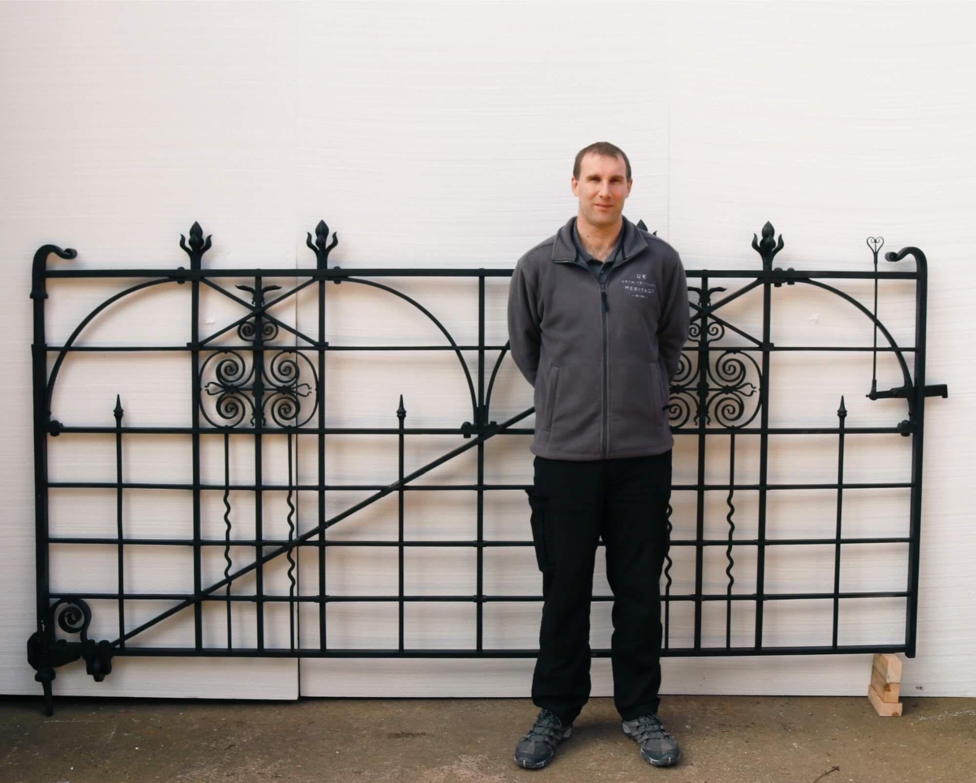 An excellent restored antique wrought iron driveway gate with original posts. This superb gate originates from the late Victorian era, traditionally crafted at the hand of a talented 19th century blacksmith and has been beautifully restored.