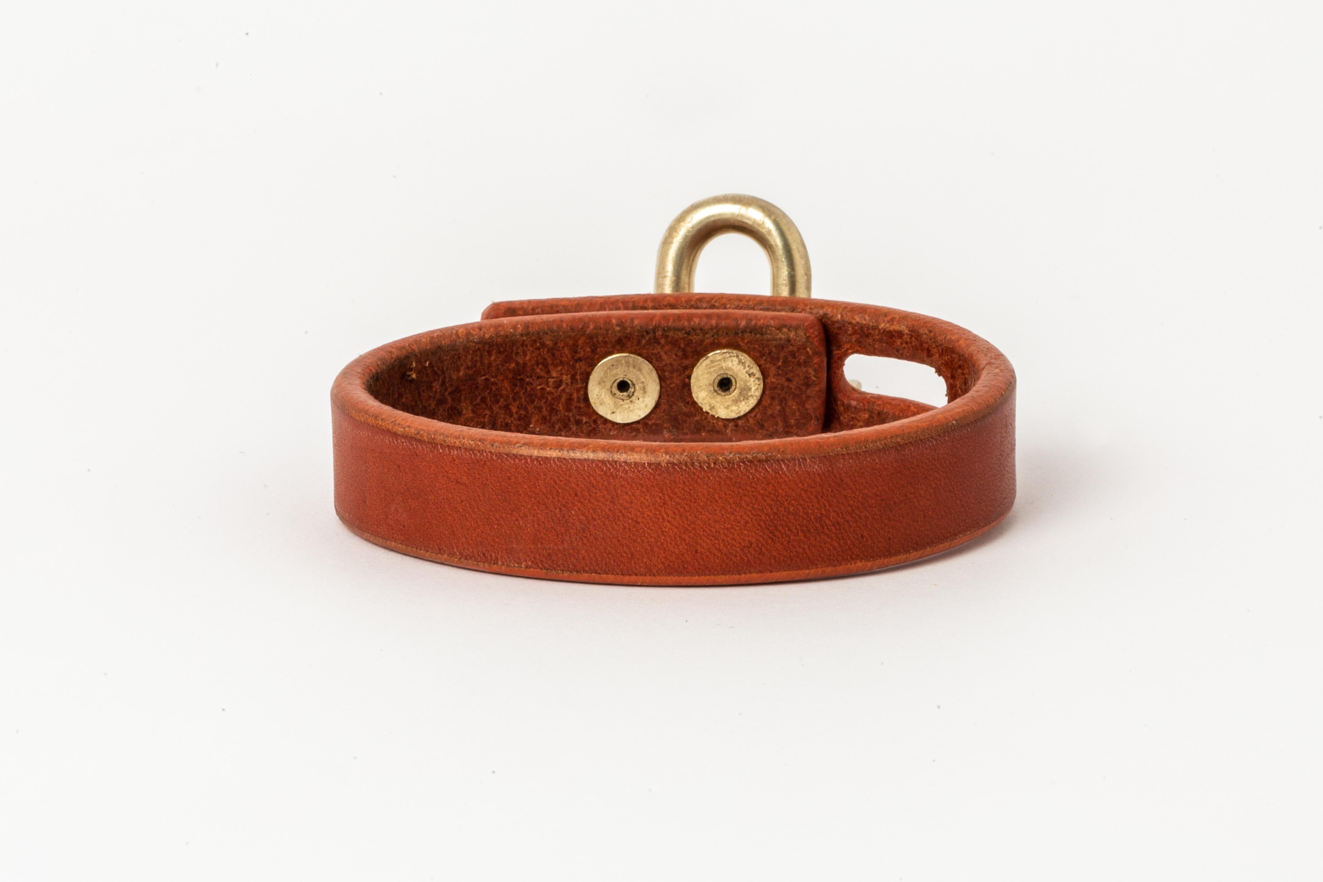Bracelet in alezan buffalo leather and acid treated gold plated brass. Items with the potential use as restraints. All P4X hardware and accessories are compatible and interchangeable. The Charm System is an interrelated group of products that can be