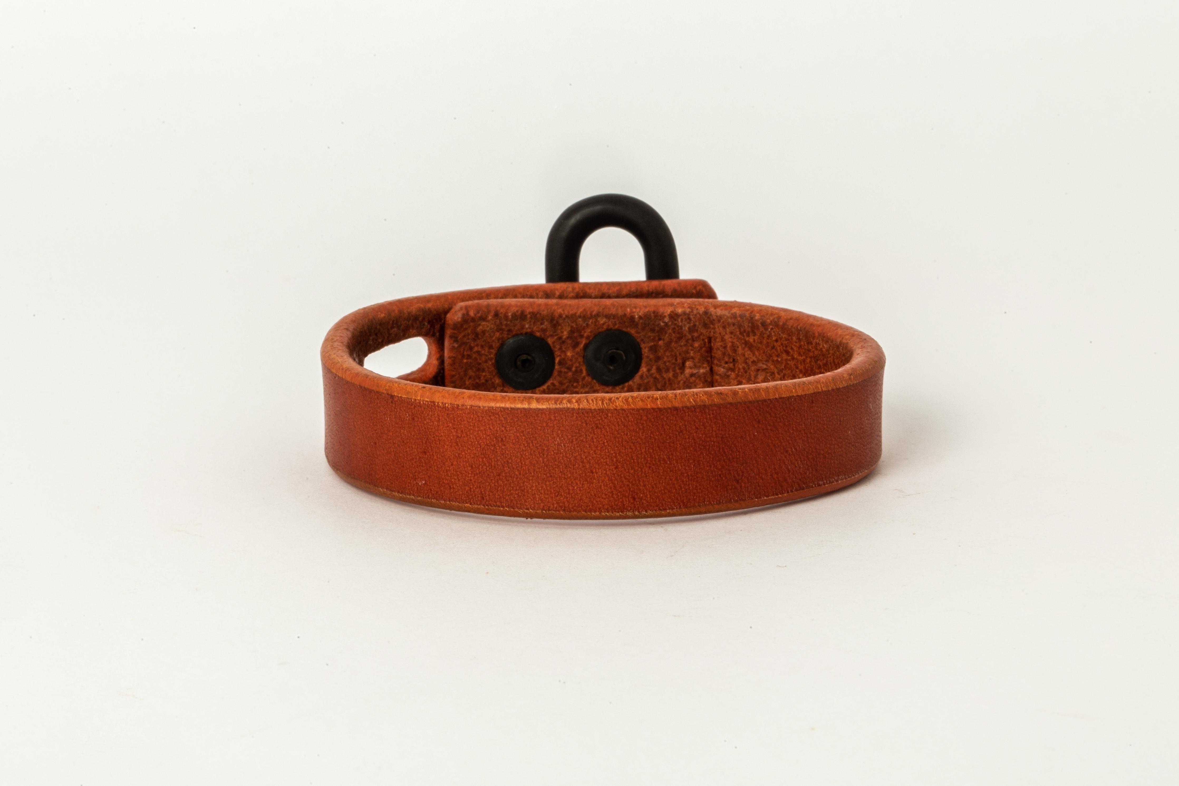 Bracelet in alezan buffalo leather and heat treated bronze. Items with the potential use as restraints. All P4X hardware and accessories are compatible and interchangeable.
The Charm System is an interrelated group of products that can be mixed and