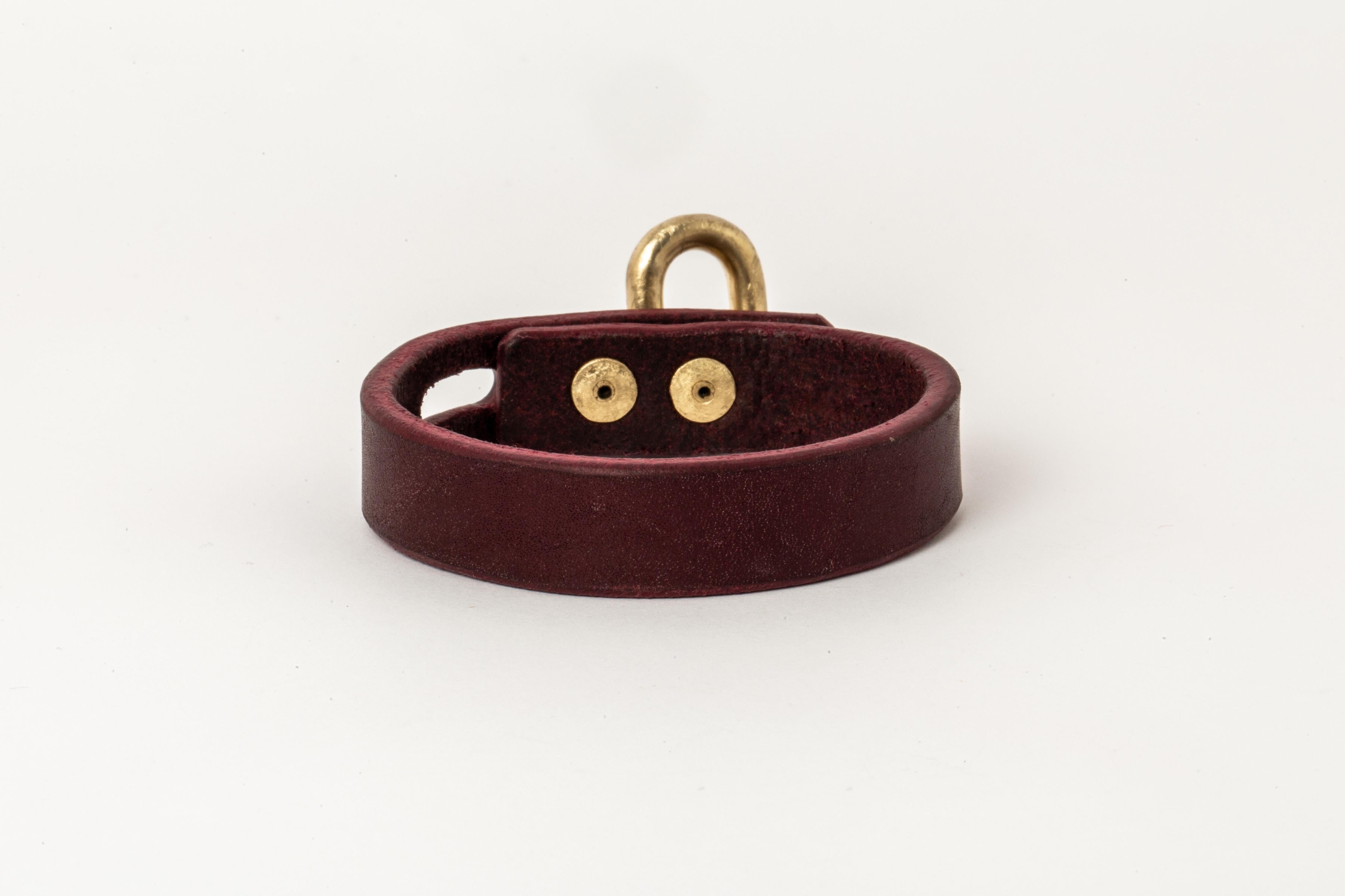 Bracelet in wine buffalo leather and acid treated gold plated brass. Items with the potential use as restraints. All P4X hardware and accessories are compatible and interchangeable. The Charm System is an interrelated group of products that can be