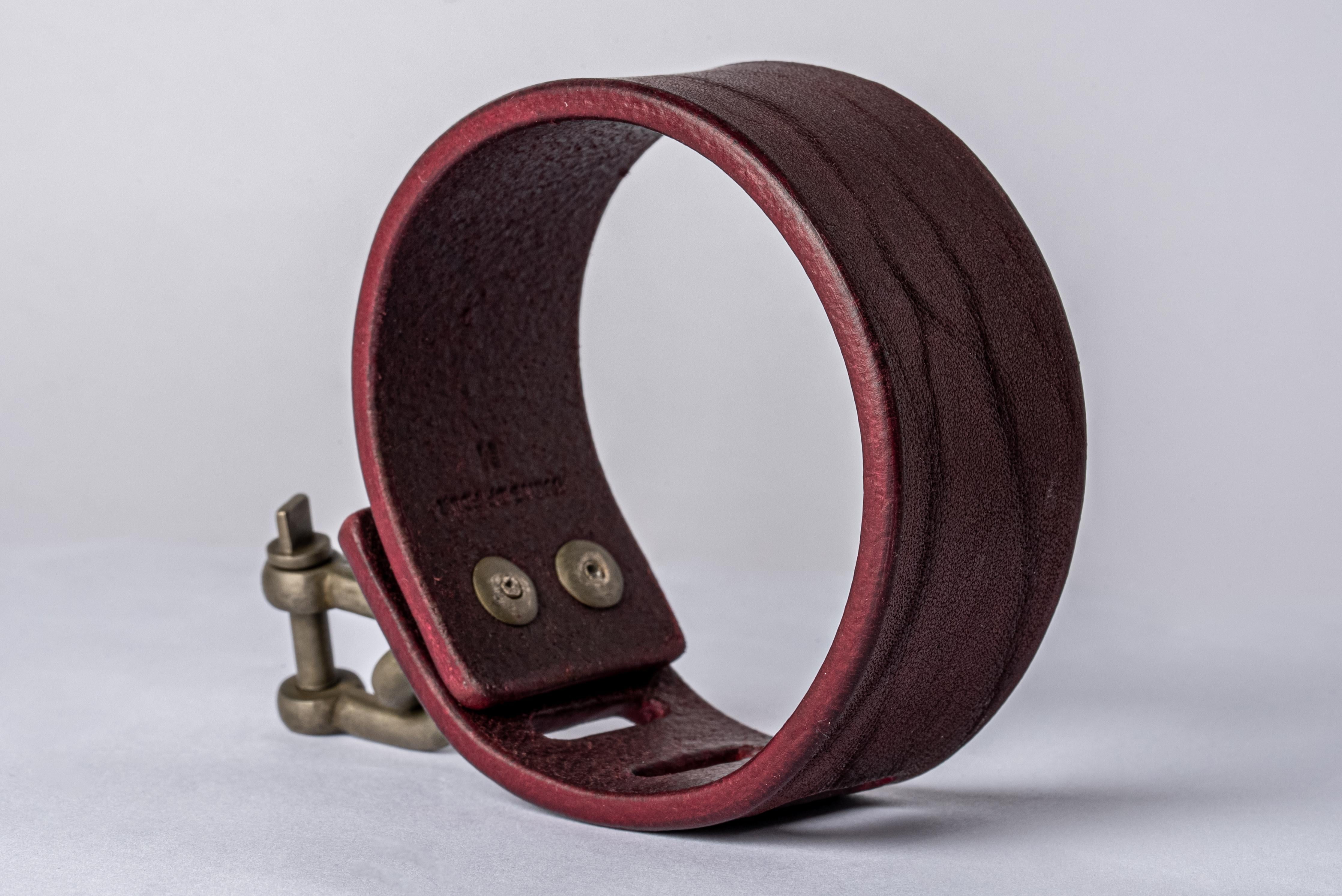Bracelet in wine buffalo leather and dirty white bronze. Items with the potential use as restraints. All P4X hardware and accessories are compatible and interchangeable. The Charm System is an interrelated group of products that can be mixed and
