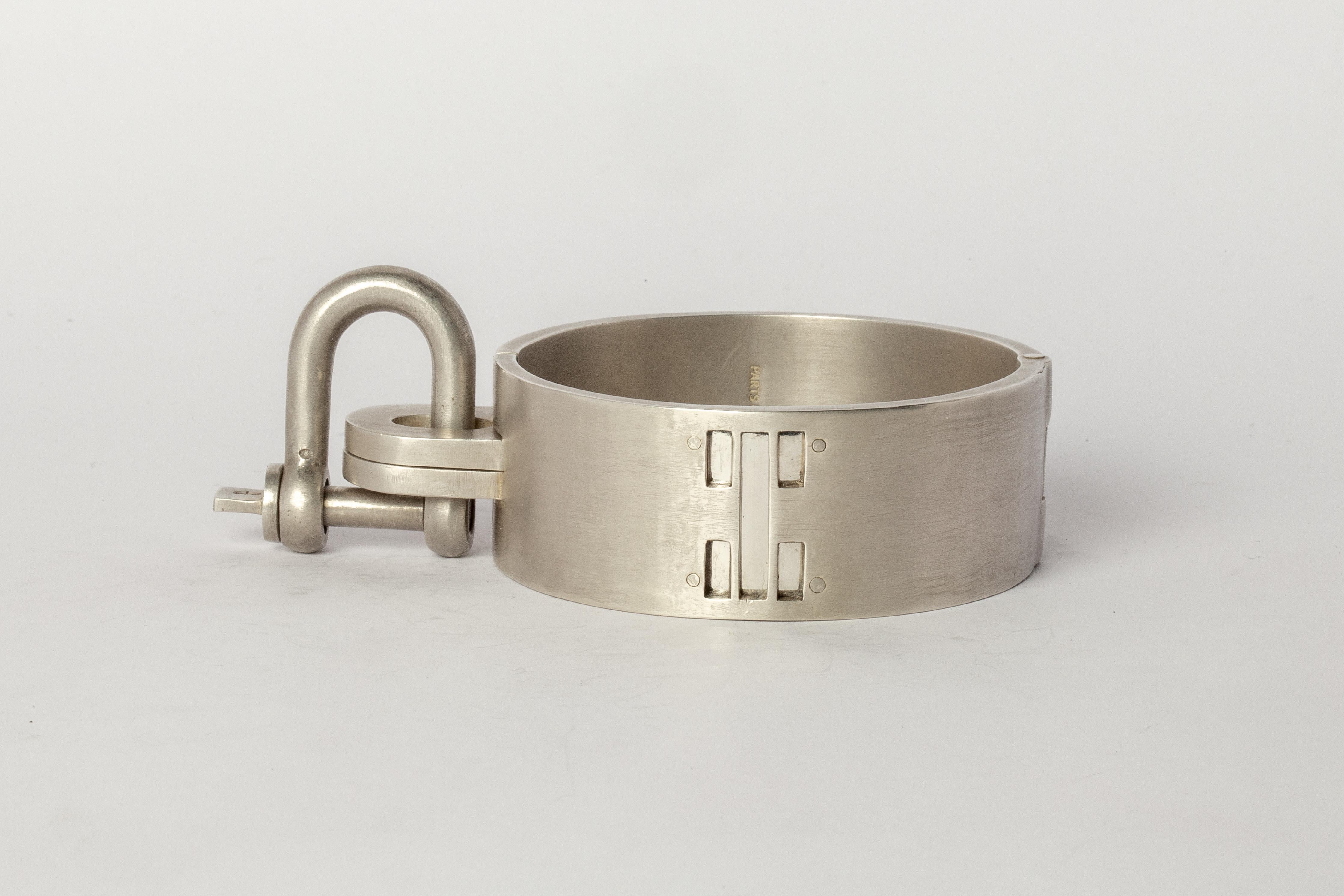 Bracelet in sterling silver, dipped in acid to create a subdued surface. Items with the potential use as restraints. The Charm System is an interrelated group of products that can be mixed and matched or worn individually. Dimensions U-bolt (H × W):