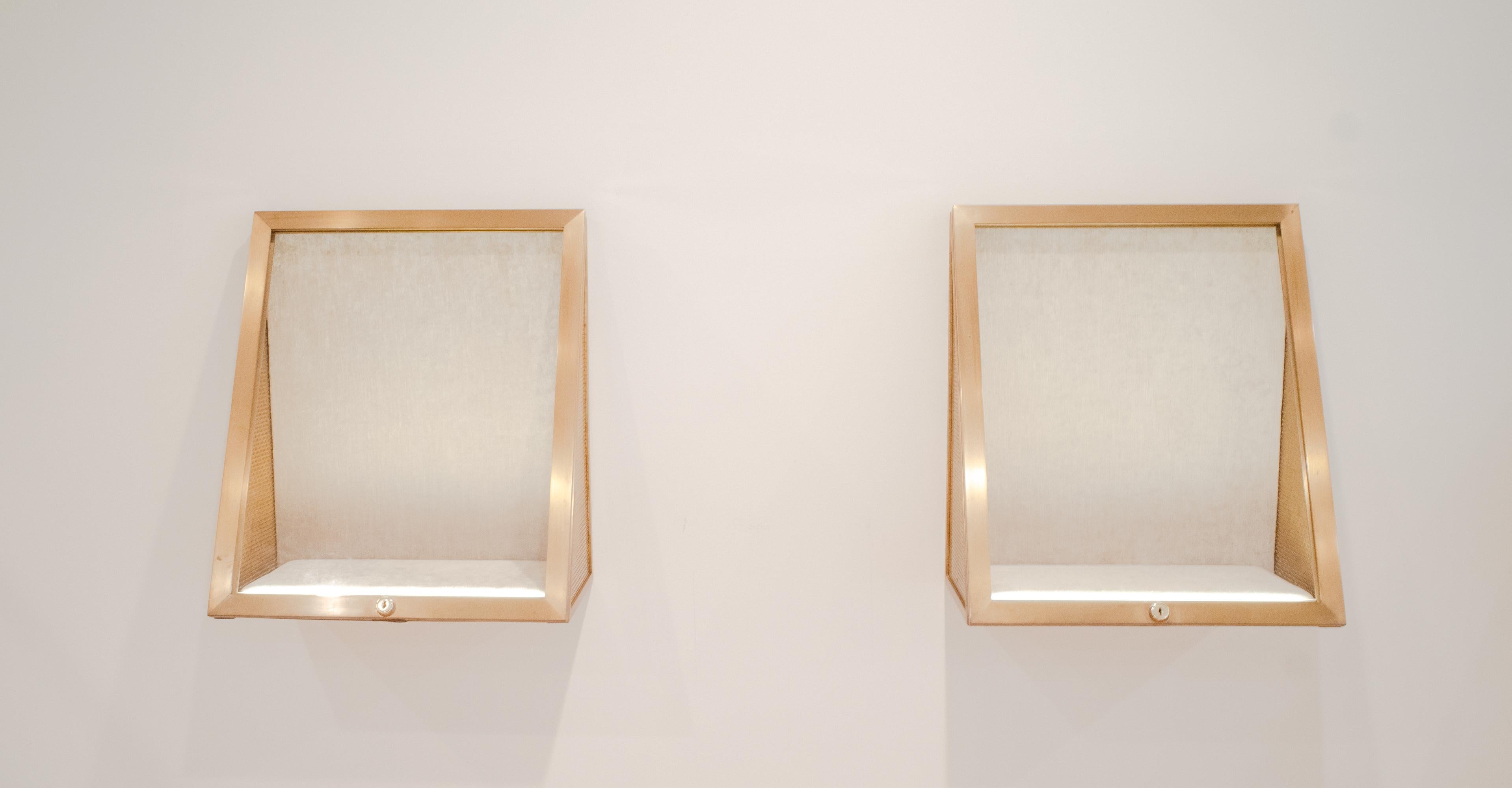 These wall mounted display cases in brass are fully lined with a warm grey velvet and have a keyed lock and are wired with LED strip lighting. They are in great condition and ready to showcase jewelry or other accessories.