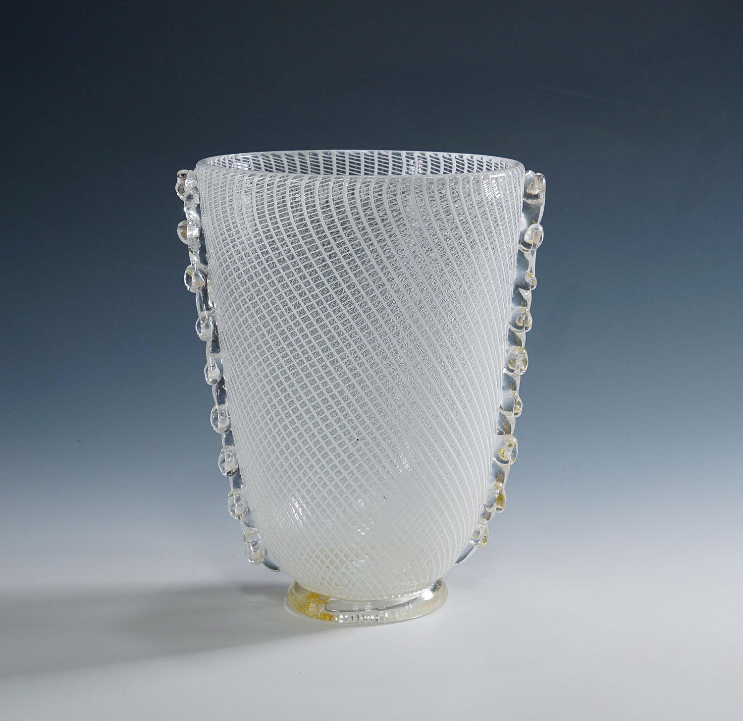 Reticello Art Glass Vase by Dino Martens for Aureliano Toso (attr.) Murano ca. 1950s

A vintage Murano art glass vase. Manufactured most probably by Aureliano Toso and designed by Dino Martens around 1950. Colorless glass with applied white