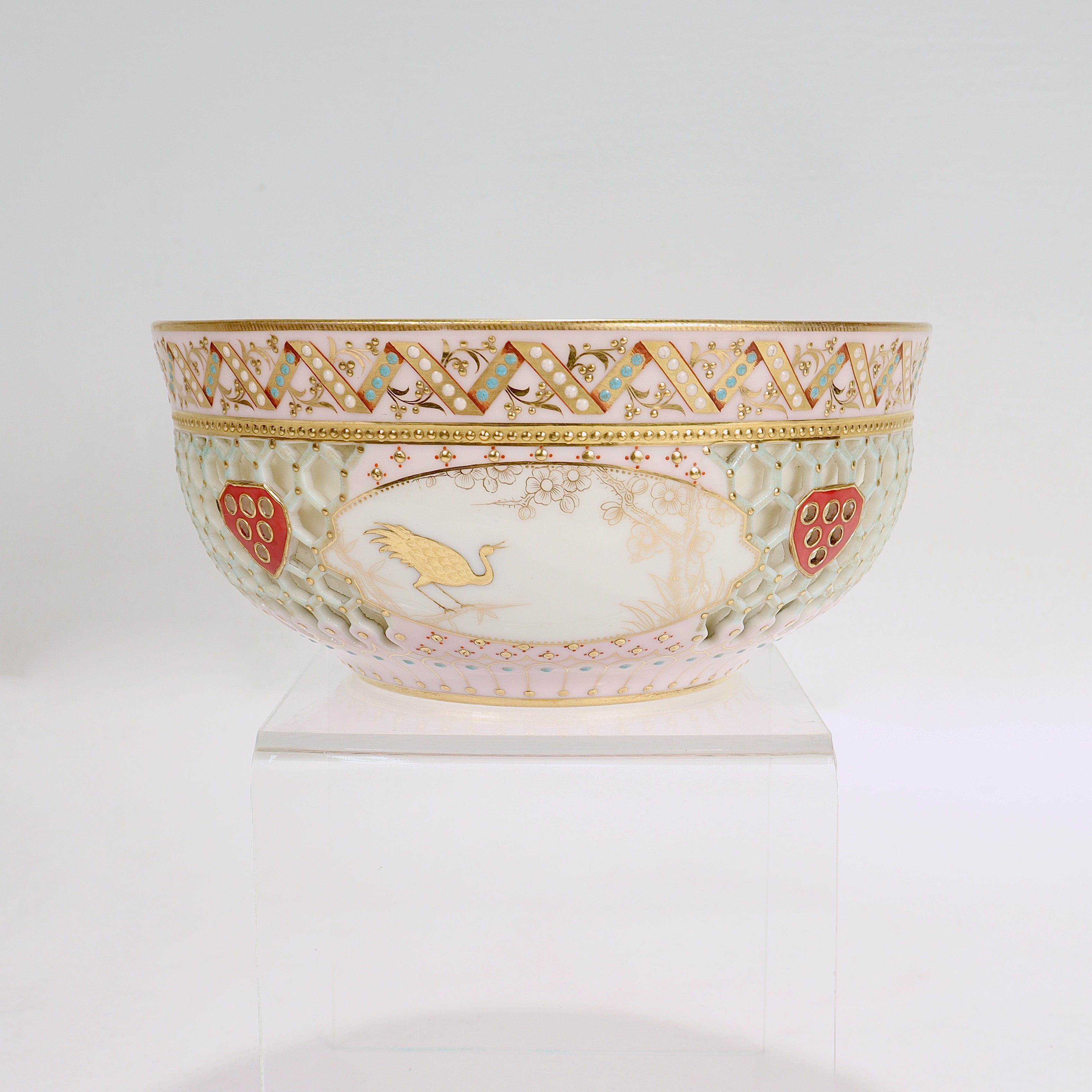 A fine antique Aesthetic Period gilt and reticulated porcelain bowl.

By the Royal Worcester Porcelain Manufactory.

Attributed to George Owen & the gilder Samuel Ranford.

Of double-walled construction with a pink ground, turquoise & white