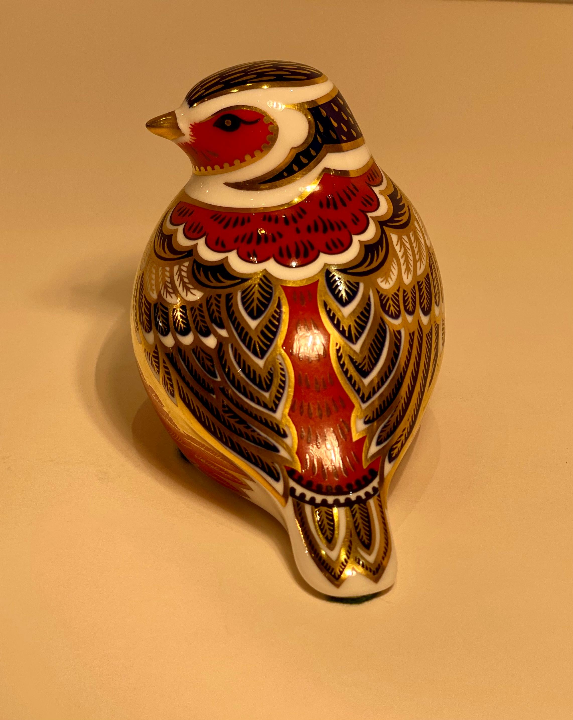 Very collectible, hand-made and hand-painted in England, retired Royal Crown Derby Fine bone china bird figurine or paperweight. The bird is richly decorated in rust, cobalt blue and accented with 22k gold in the famous Japonisme style Imari pattern
