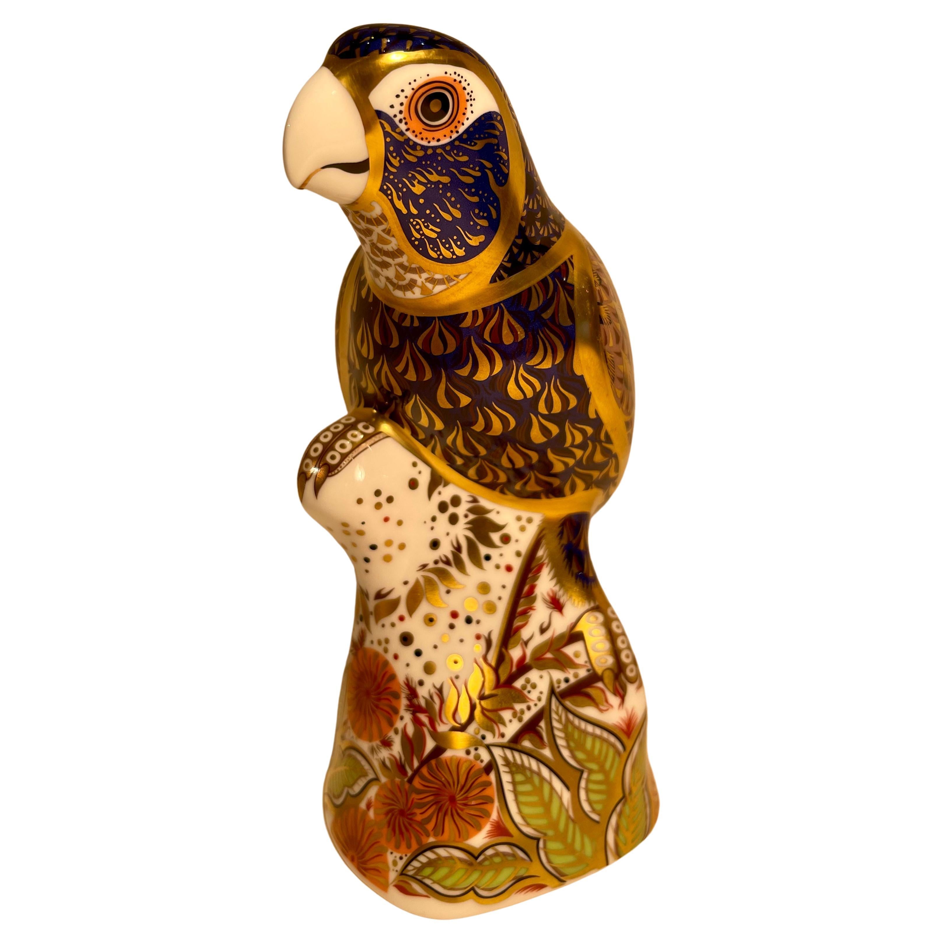 Very collectible, hand-made and hand-painted in England, retired Royal Crown Derby fine bone china parrot figurine or paperweight. This is a larger size piece measuring approximately 6.25