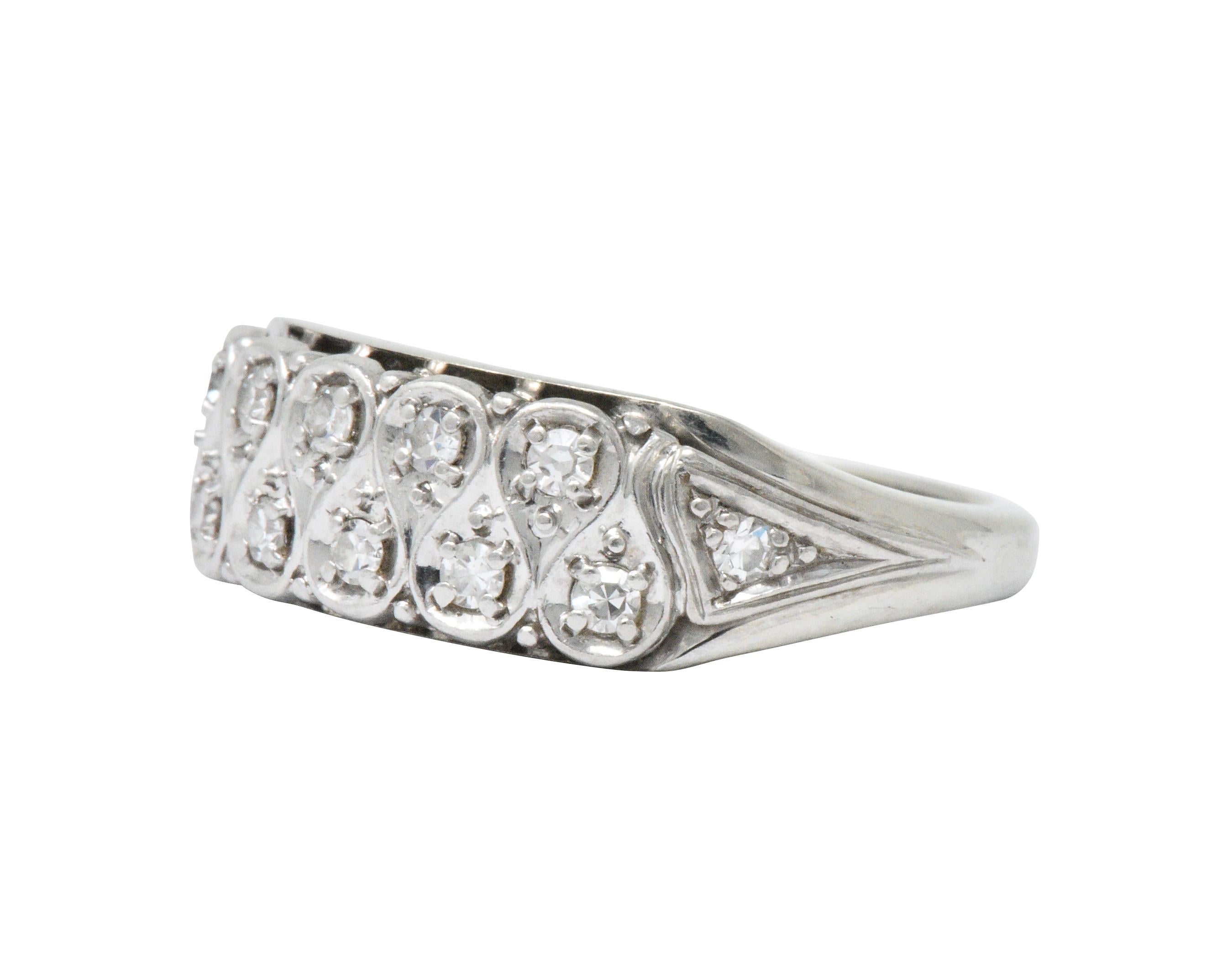 Set to the front with single cut diamonds, weighing approximately 0.20 carats total, eye-clean and white

Undulating ribbon style motif 

Ring Size: 6 & Sizable

Top measures 6.8 mm and sits 3.5 mm high

Total Weight: 4.4 Grams

Tested as 18k