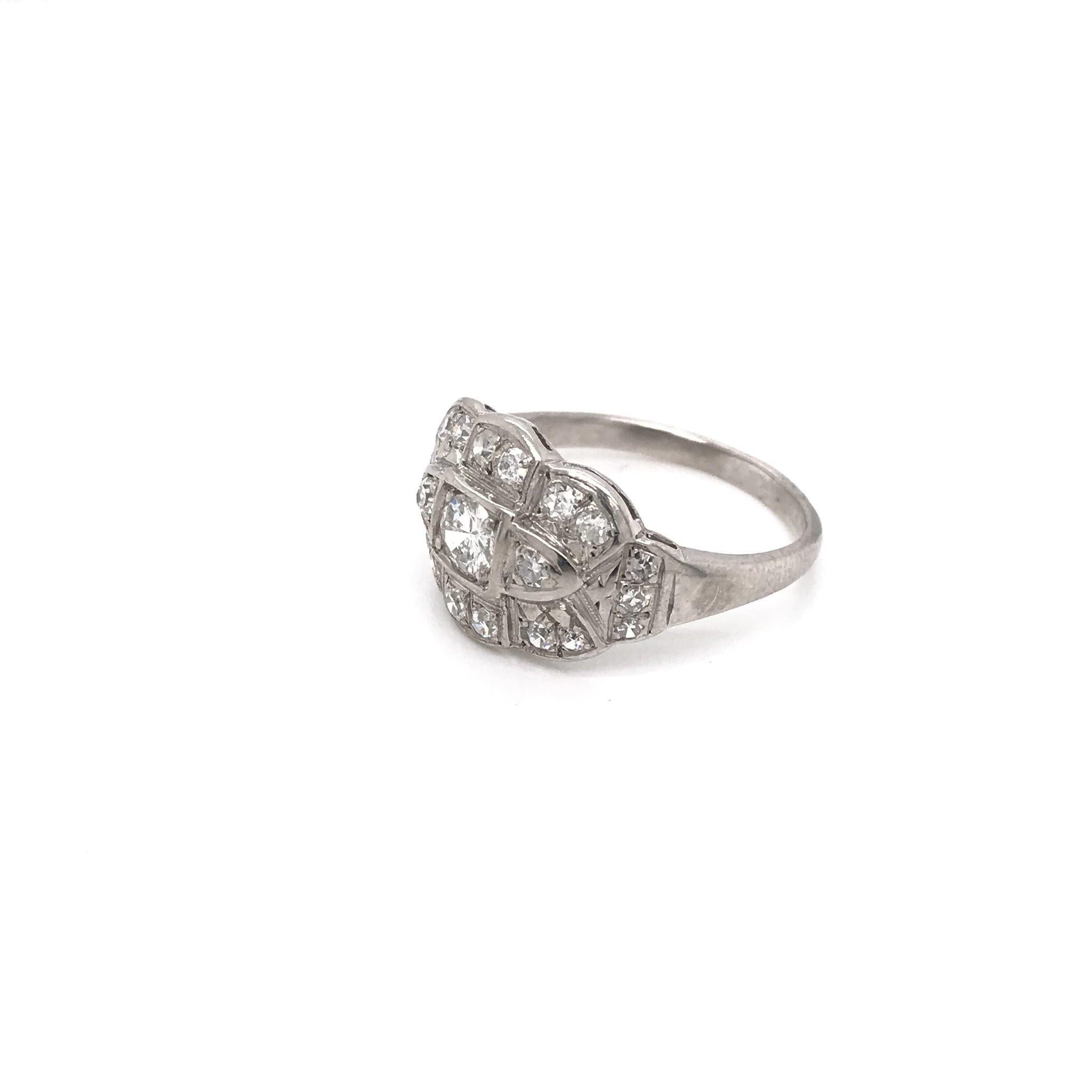 This vintage piece was crafted sometime during the Mid Century design period ( 1940-1960 ). The setting is 14k white gold and features 21 sparkling white diamonds. This ring is beautifully classic and understated, a perfect piece to wear everyday.