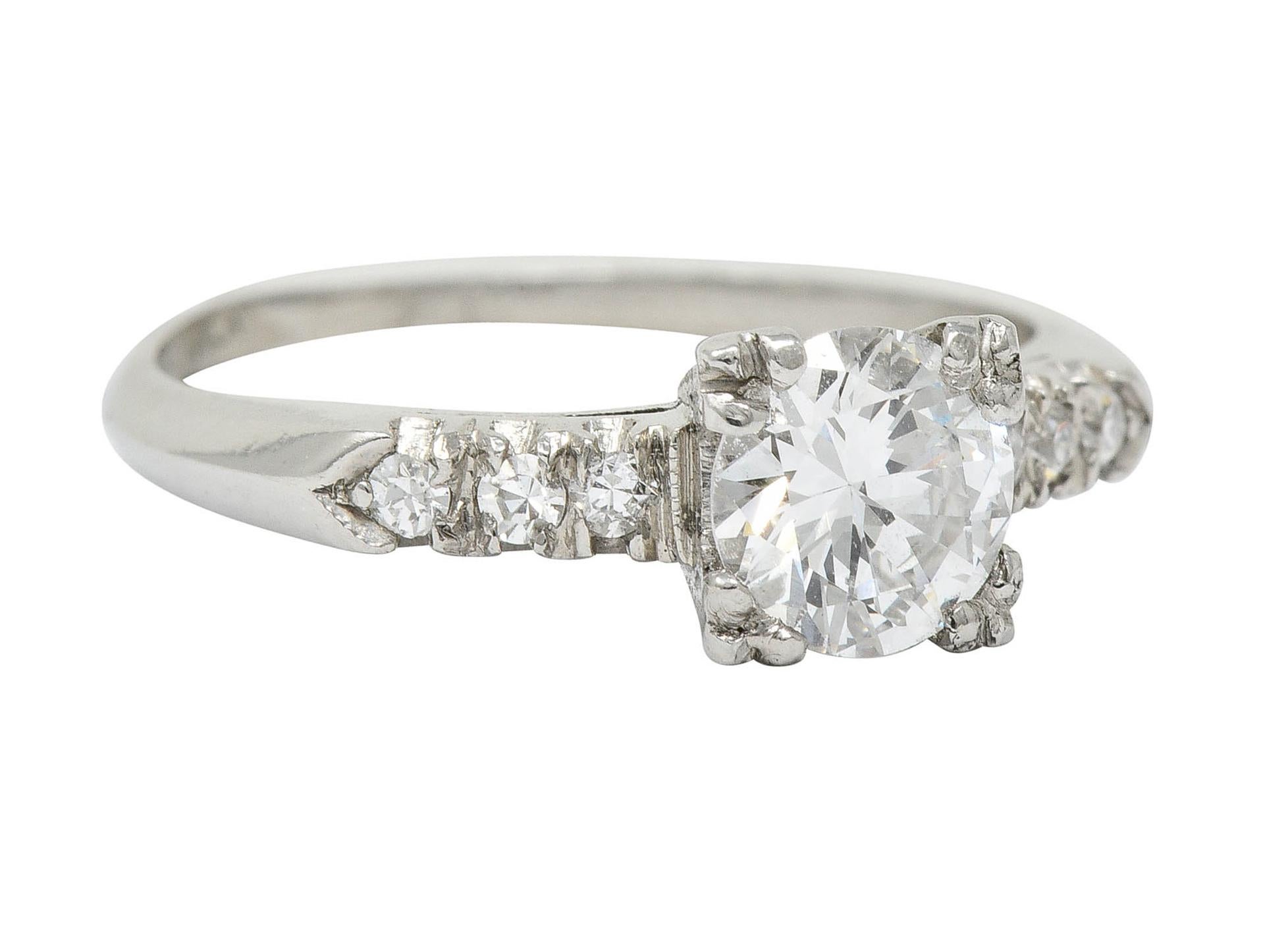 Engagement ring is designed with a stylized square form head, fishtail set shoulders, and a knife edge shank

Centering a transitional cut diamond weighing approximately 0.60 carat; J color with SI clarity

Flanked by single cut diamonds weighing in