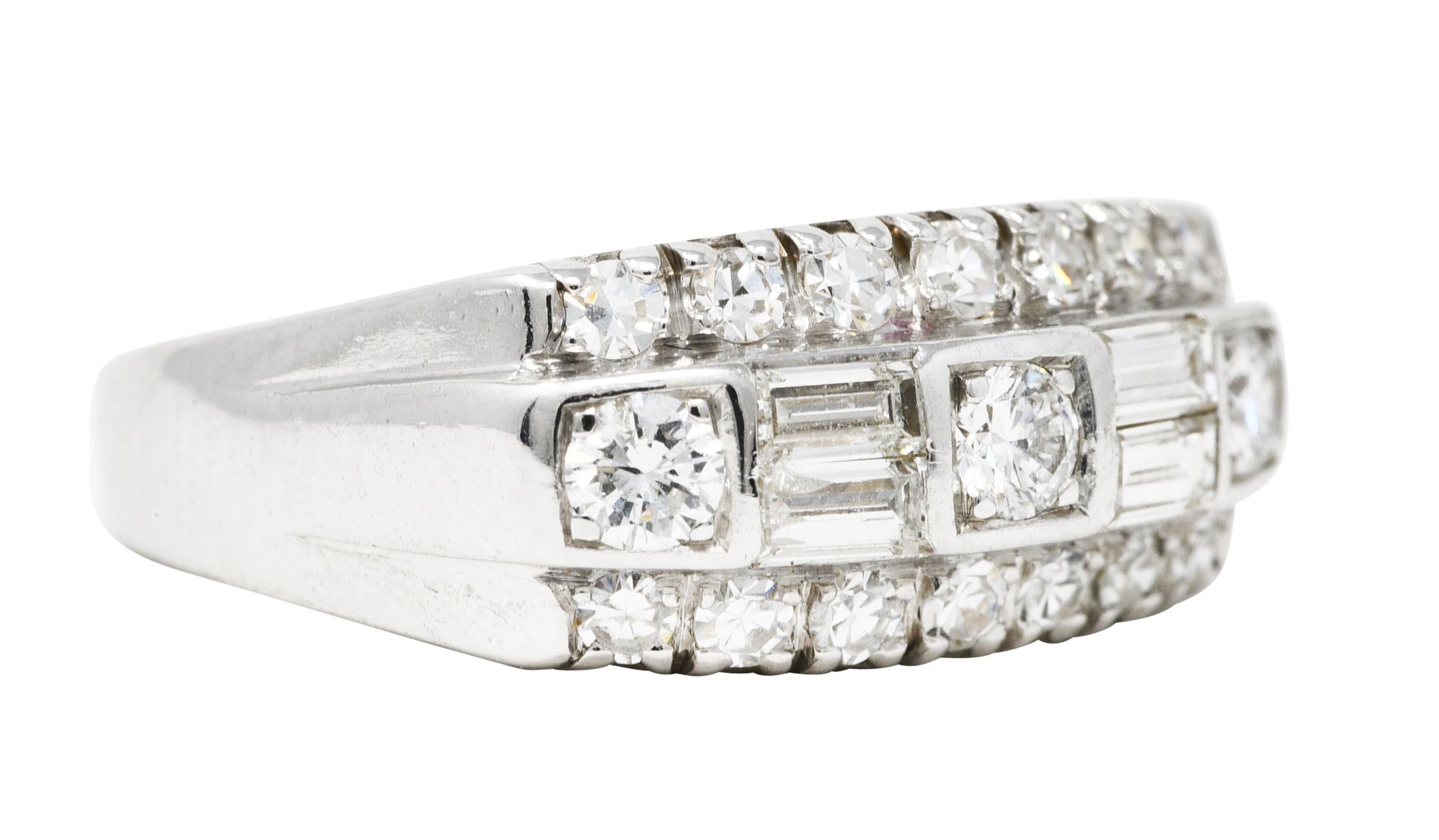 Band is designed as a rectangular form set with three rows of diamonds - East to West. Center row has round brilliant cut diamonds alternating with baguette cut diamonds. Flanked North to South by fishtail set single cut diamonds. Total diamond