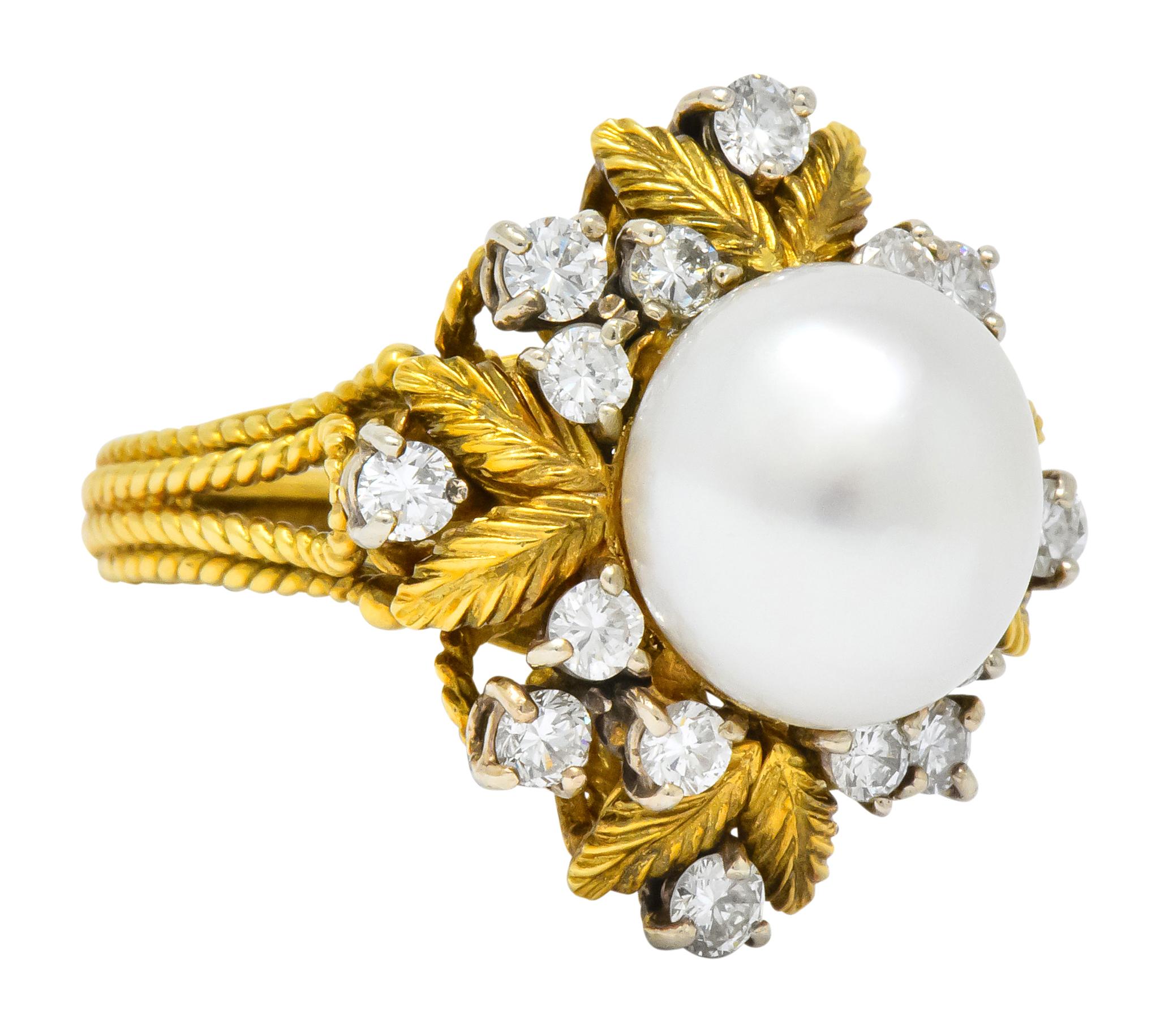 Centering a round cultured south sea pearl measuring 10.7 mm, cream body color with rosé overtone and good luster

Surrounded by detailed gold leaves with round brilliant cut diamonds, prong set in white gold, weighing approximately 0.95 carat