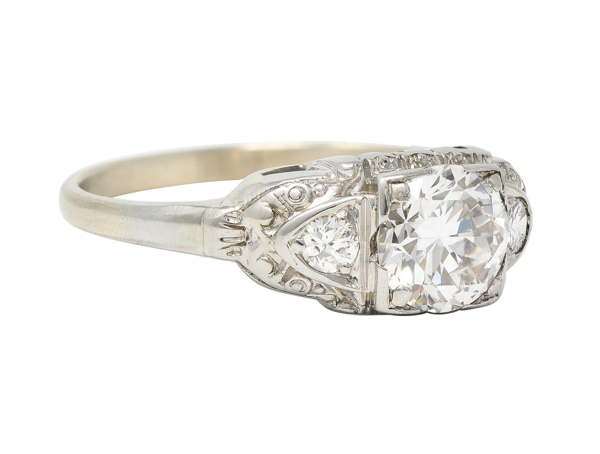 Featuring a transitional cut diamond weighing approximately 0.85 carat - J color with VS clarity
Set low in a square form head and flanked by two transitional cut diamonds
Weighing collectively approximately 0.10 carat - eye clean and
