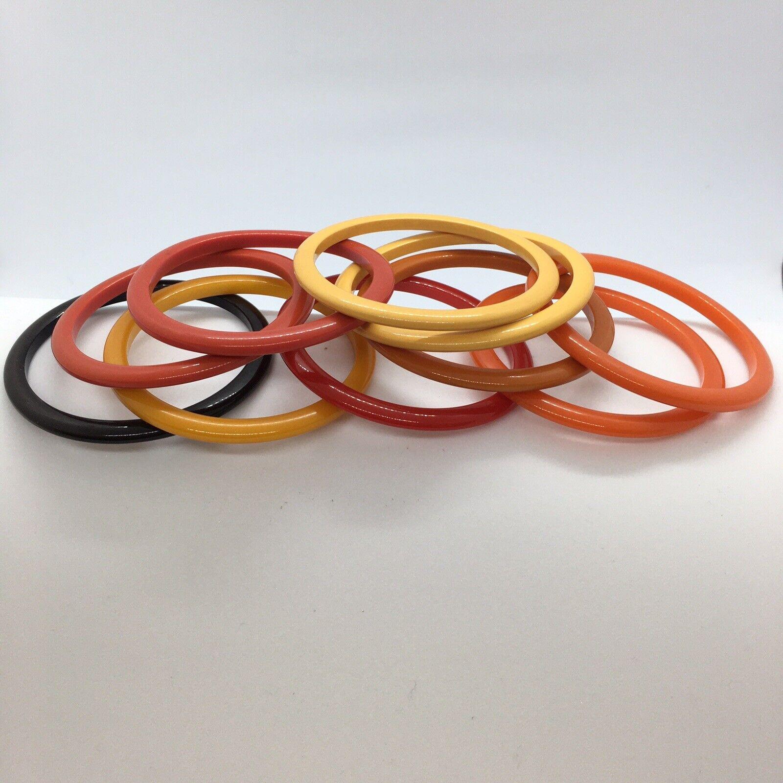 Retro 10 Pc Bakelite Bangle Bracelet Opaque Pristine Domed Sliced Rainbow
Colors Lime, Cherry, Butterscotch, Red, Orange, Russet and Black
Dimensions 2.5 inch inner Diameter, measuring 7.85 inch wrist size, 3 inch Outer diameter, each are 1/8 inch