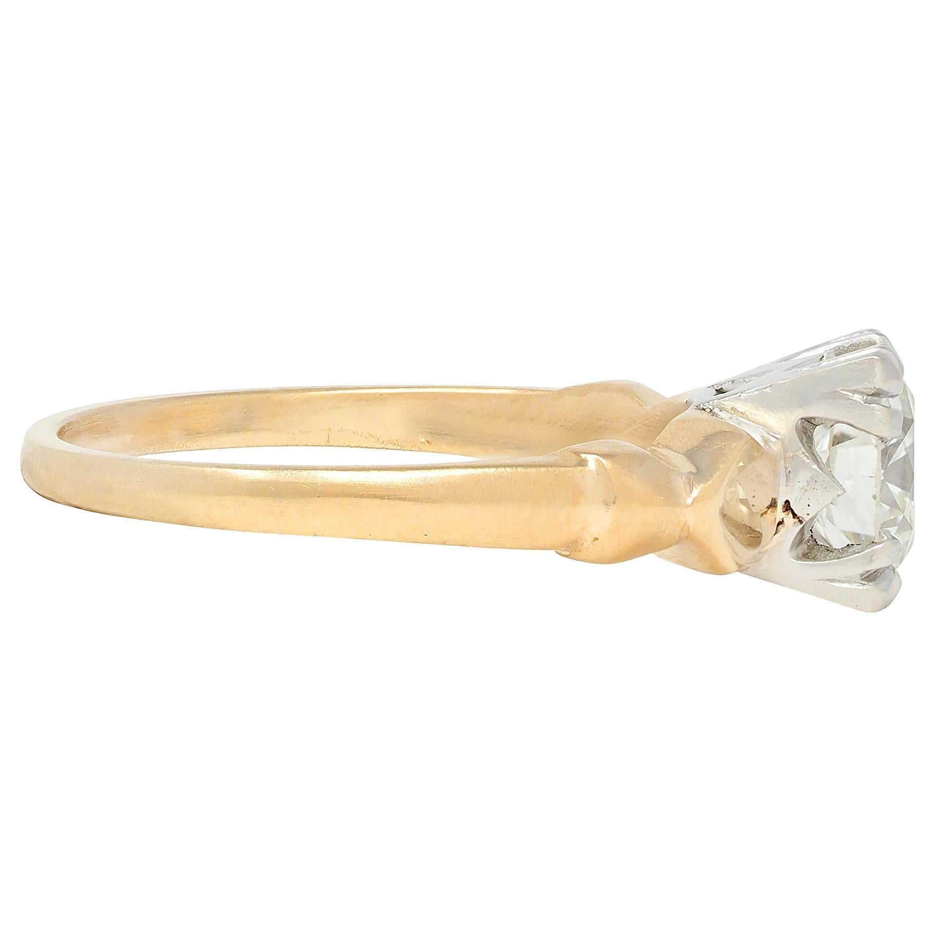 Centering a transitional cut diamond weighing approximately 1.02 carats - H color with VS2 clarity
Set with tri-split prongs in a square form platinum head and flanked by gold shoulders
Grooved with bowtie motif
Stamped with hallmarks for 14 karat