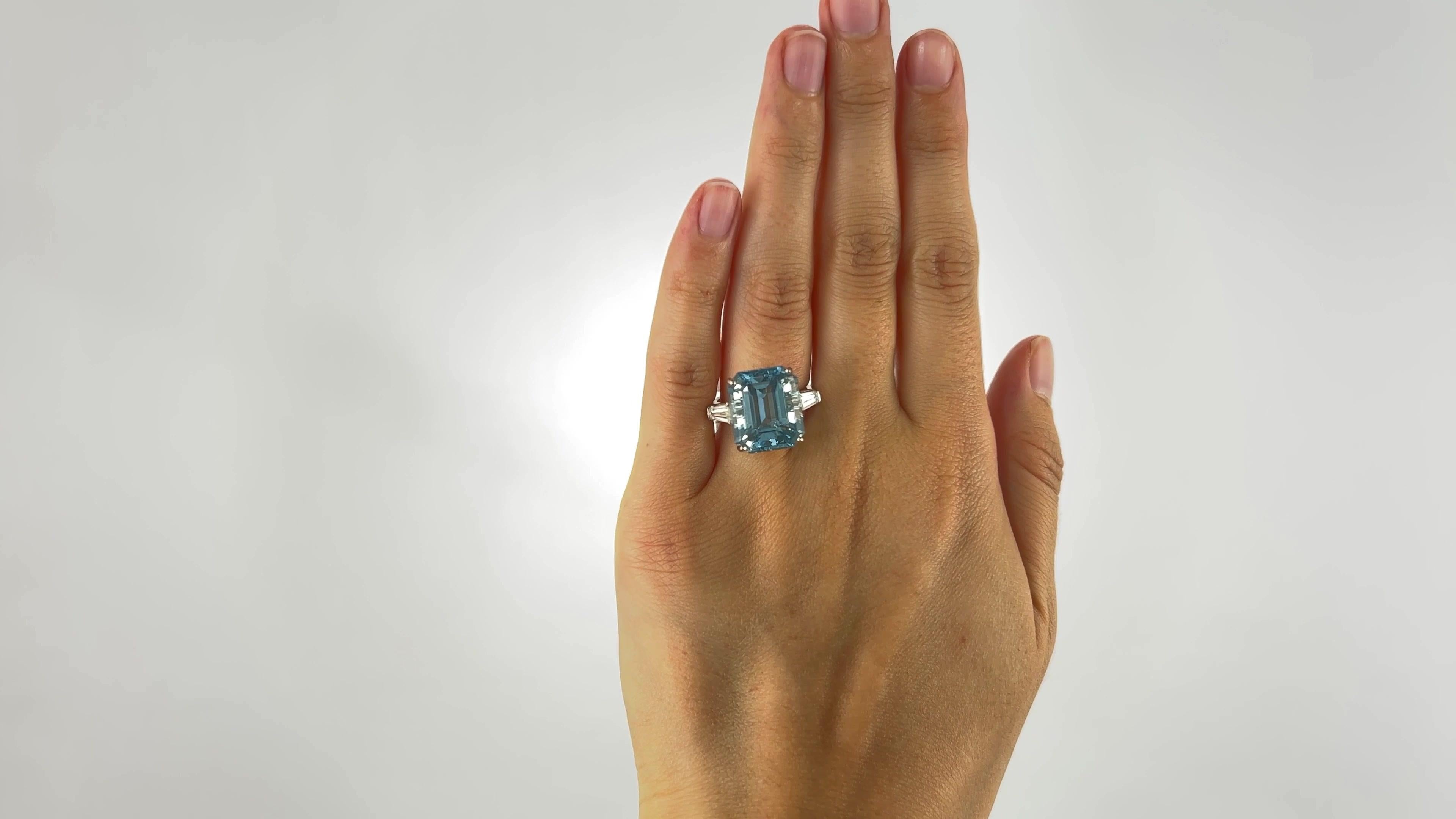One Retro 10.58 Carats Aquamarine Diamond Platinum Ring. Featuring one rectangle step cut aquamarine of 10.58 carats. Accented by two tapered baguette cut diamonds with a total weight of approximately 0.60 carat, graded F color, VS clarity. Crafted