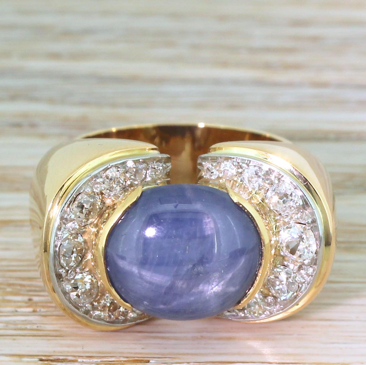 One of the most spectacular rings we’ve ever had the pleasure or marketing. The wonderfully chunky piece features a light, medium blue star sapphire which, in sunlight, displays a strong and clear asterism. The sapphire sits in a daringly shaped