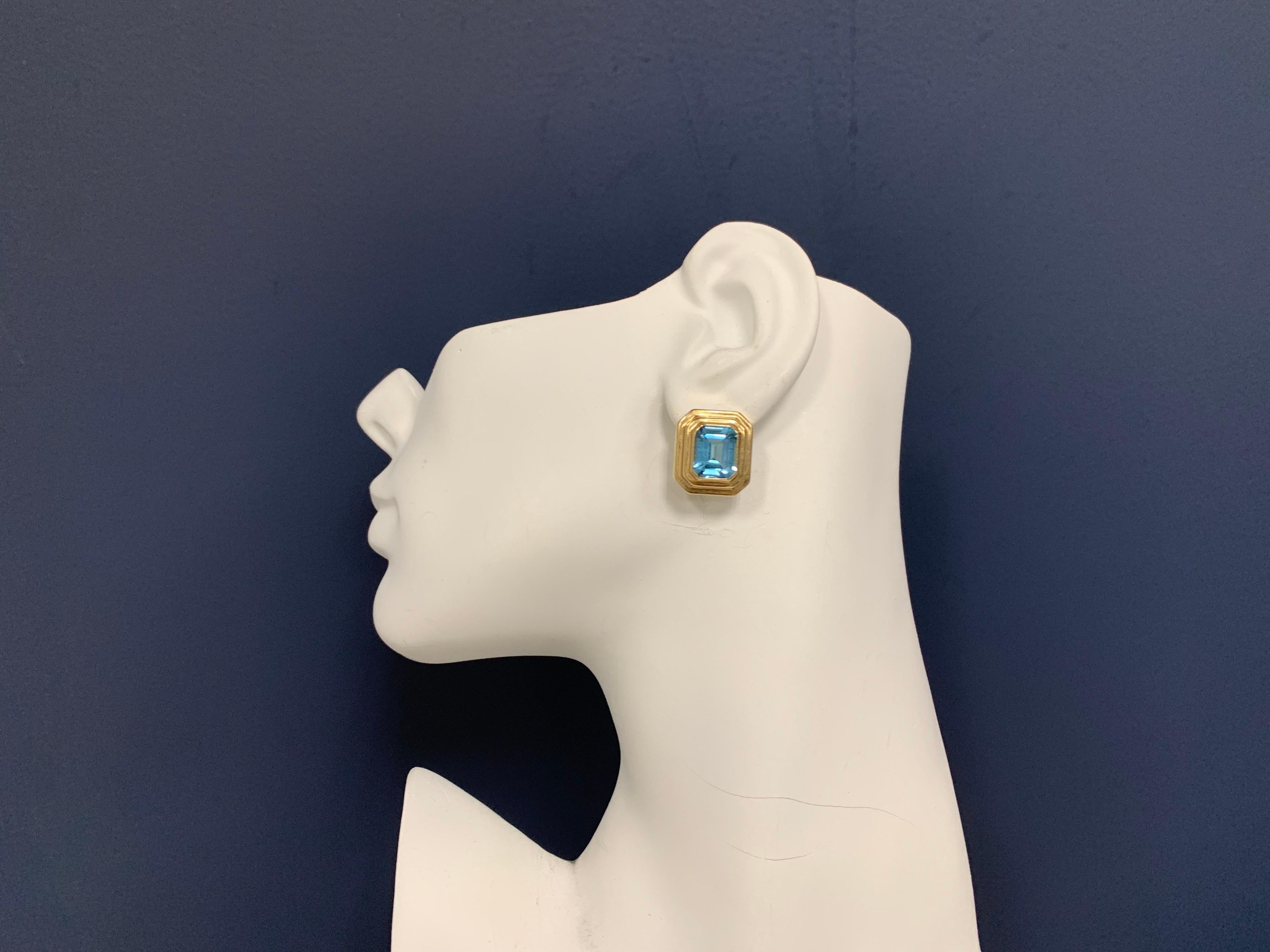 Retro 14k Gold Natural Emerald Cut Blue Topaz Earrings Circa 1970. 

Each stone measures approximately 12x9.5x6.5mm. Total weight is approximately 12 carat, actual weight of the earrings is 7.2 grams.