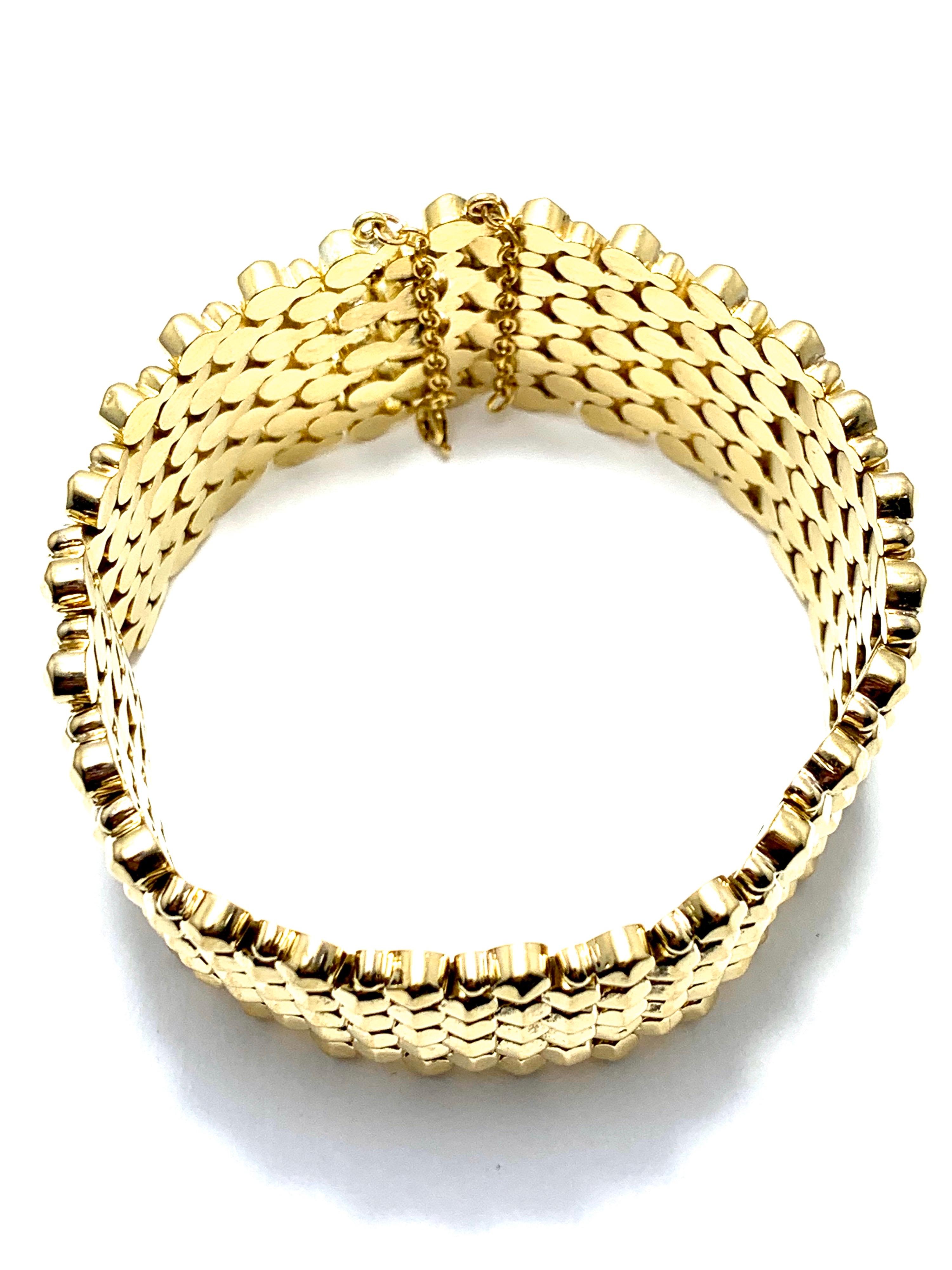 This is a fabulous bracelet to own.  The 1.25 inch wide 18 karat yellow gold bracelet has a super soft inside, with a cone shaped outside.  The bracelet features a triple locking closure, with a safety chain.  This bracelet measures 8.00 inches in