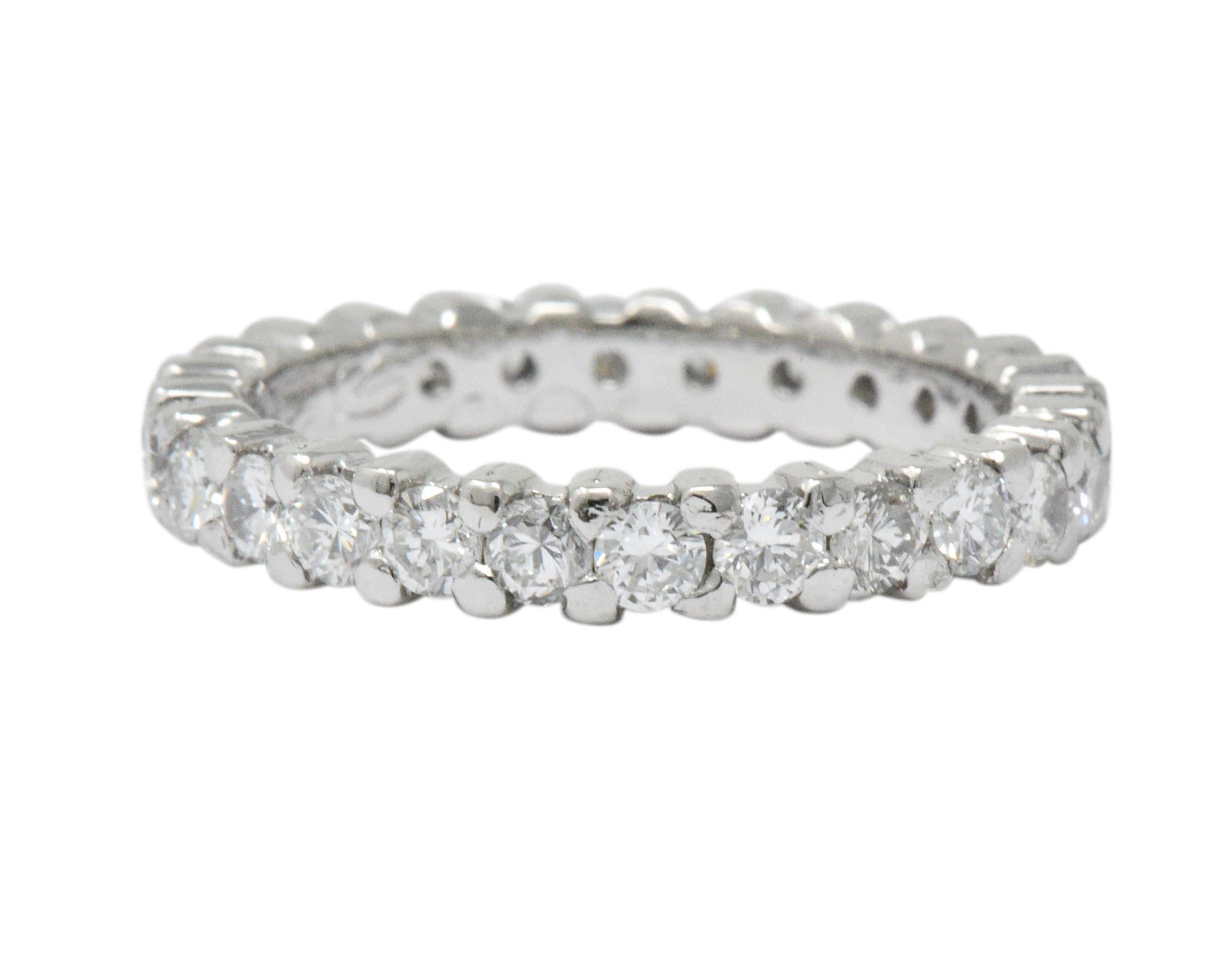 Set with 26 round brilliant cut diamonds weighing approximately 1.30 carats total, GHI color and VS to SI clarity

Prong set for a sleek feel

Tested to be platinum and engraved 

Circa 1957 and great for stacking

Ring Size: 5 & Not Sizable

Top