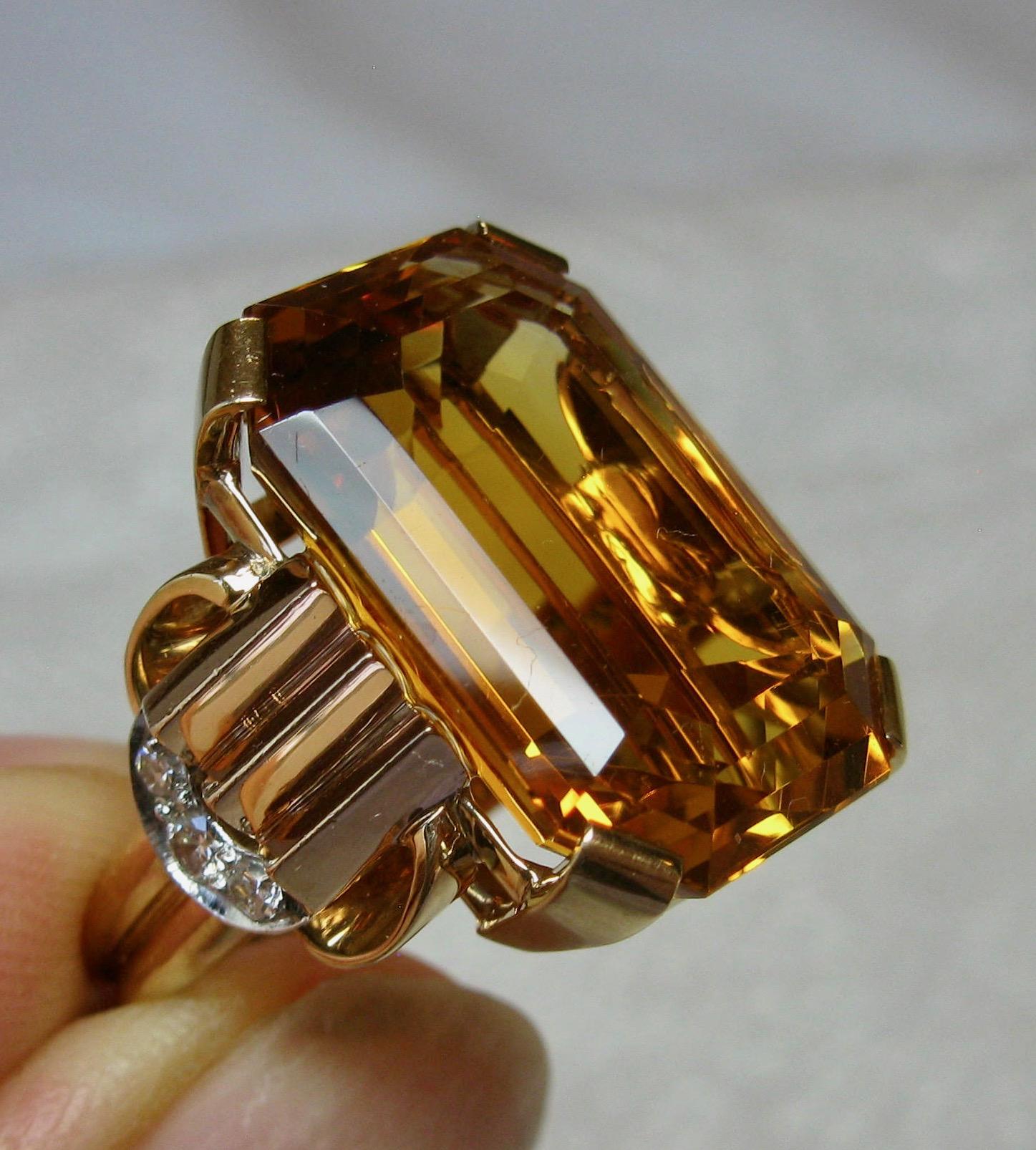 An absolutely magnificent 14 Carat emerald cut Citrine ring accented by 6 sparkling white Diamonds in a classic setting in 14 Karat Rose Gold by the highly esteemed jewelers, Walton & Co.  The ring is testament to the stunning design of the Retro -