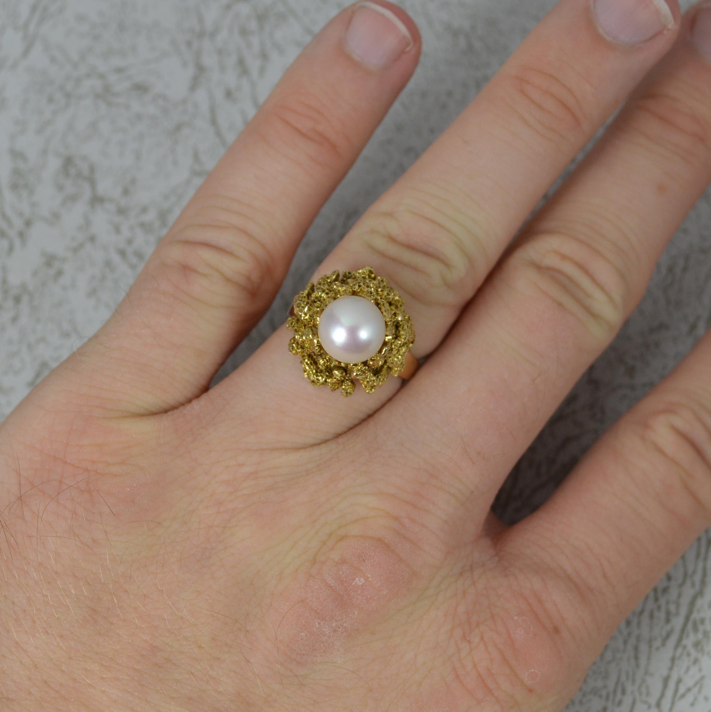 A superb Pearl solitaire statement ring.
Solid 14 carat yellow gold example.
Set with a single round pearl to centre. 8.2mm diameter. Surrounding is a naturalistic gold design.
Protruding 14.1mm off the finger.

CONDITION ; Very good. Well set