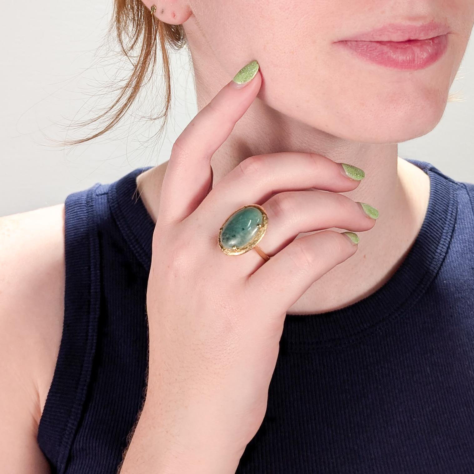 A fine estate 14k gold and jade ring.

Dating to the 1970s, the jadeite cabochon is prong set in a textured 14k gold setting. The undercarriage has an openwork design.

A fun, retro 1970s ring!

Ring Size: ca. 6 1/2

Items purchased from this dealer