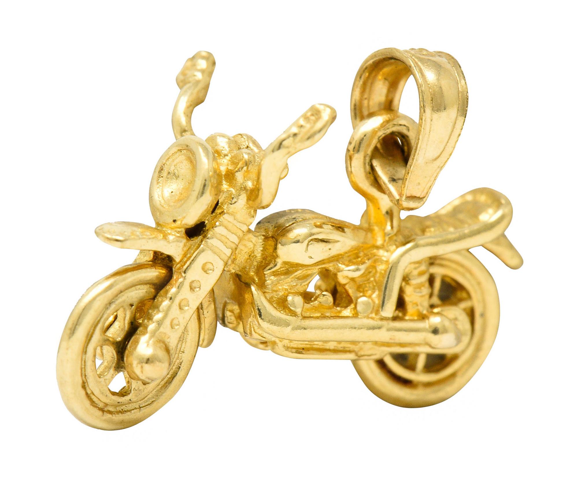 Charm is designed as a highly rendered motorcycle

With pivoting handle bars and spinning wheels

Completed by bale

With maker's mark and stamped 14K for 14 karat gold

Circa: 1950s

Measures: 5/8 x 3/4 inch

Total weight: 2.4 grams

Gleaming.