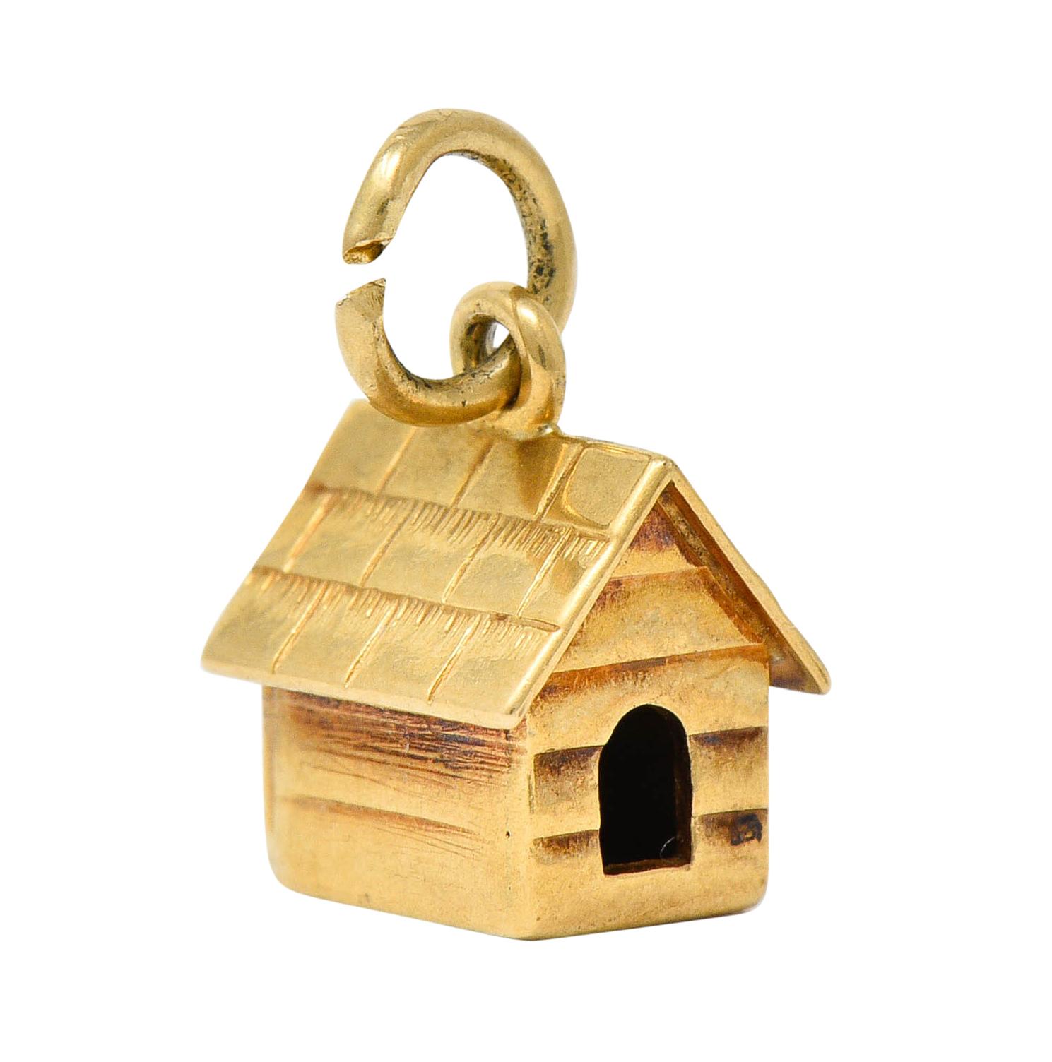 Charm is designed as a pitched roof doghouse

With deeply engraved shingles and siding

Completed by a jump ring bale

With maker's mark and stamped 14K for 14 karat gold

Circa: 1950s

Measures: 1/4 x 5/16 inches

Total weight: 1.3 grams

Cute.