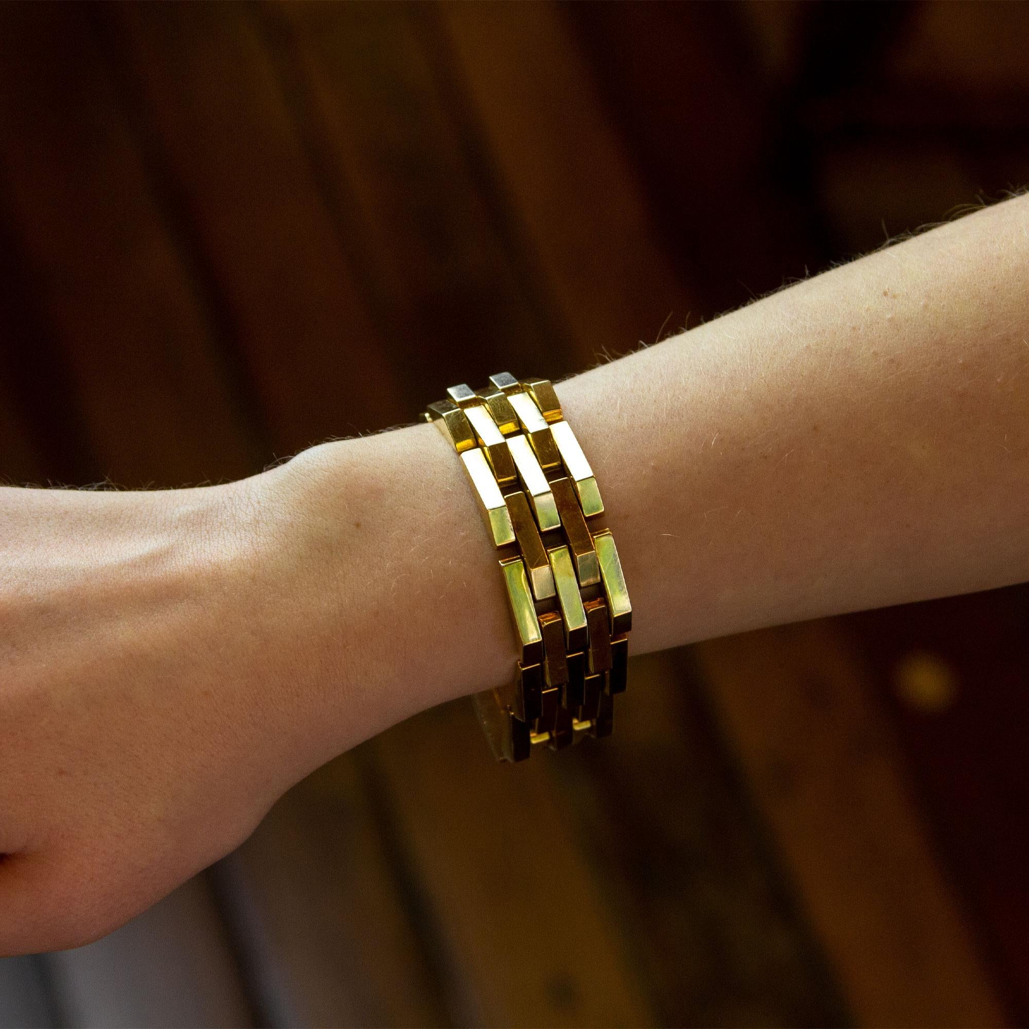 A beautiful quality 14 karat yellow gold tank bracelet from the Retro period. The piece is crafted from geometric hollow bars which are connected to form a bracelet, which gets its name from its likeness to the treads on military tanks. Tank