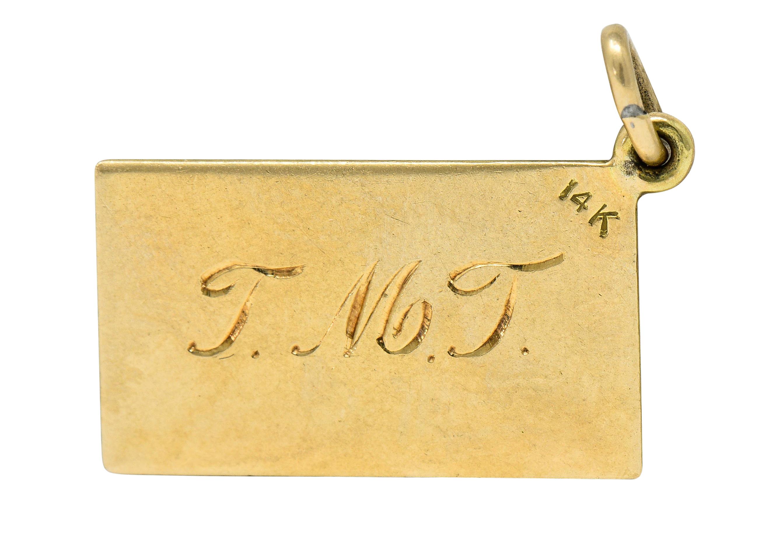 Rectangular charm is designed as a retro style postal card

With green enamel finely detailed as an address line and a one cent Jefferson stamp

Deeply engraved with a name and initials

Stamped 14K for 14 karat gold

Circa: 1940s

Measures: 7/16 x