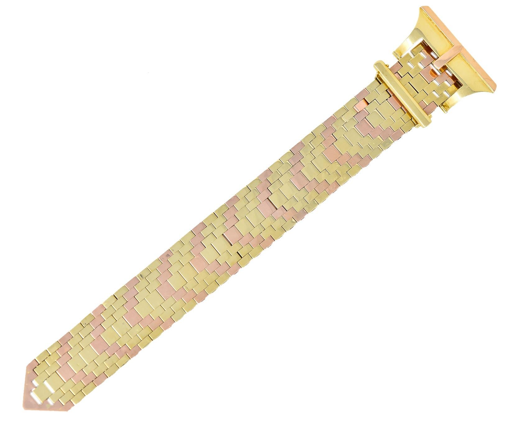 Bracelet is designed as a malleable strap of intermingled links of rose and yellow gold

With a stylized buckle of high polished gold accented by a rose gold border

Completed by locking hinged closure 

With maker's mark and Netherland assay