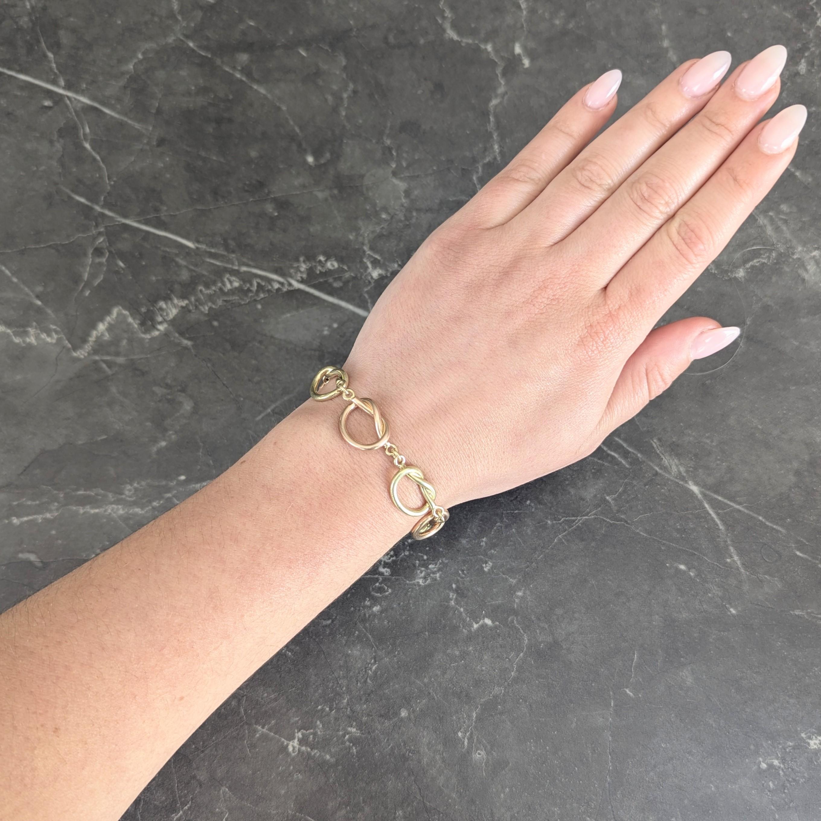 Comprised of alternating rose and yellow gold knot links
Looping pretzel style knots are connected via jump rings
Completed by spring clasp closure
Stamped for 14 karat gold
Width at Widest: 1/2 inch
Bracelet Size: 6 1/2 inch circumference with 3
