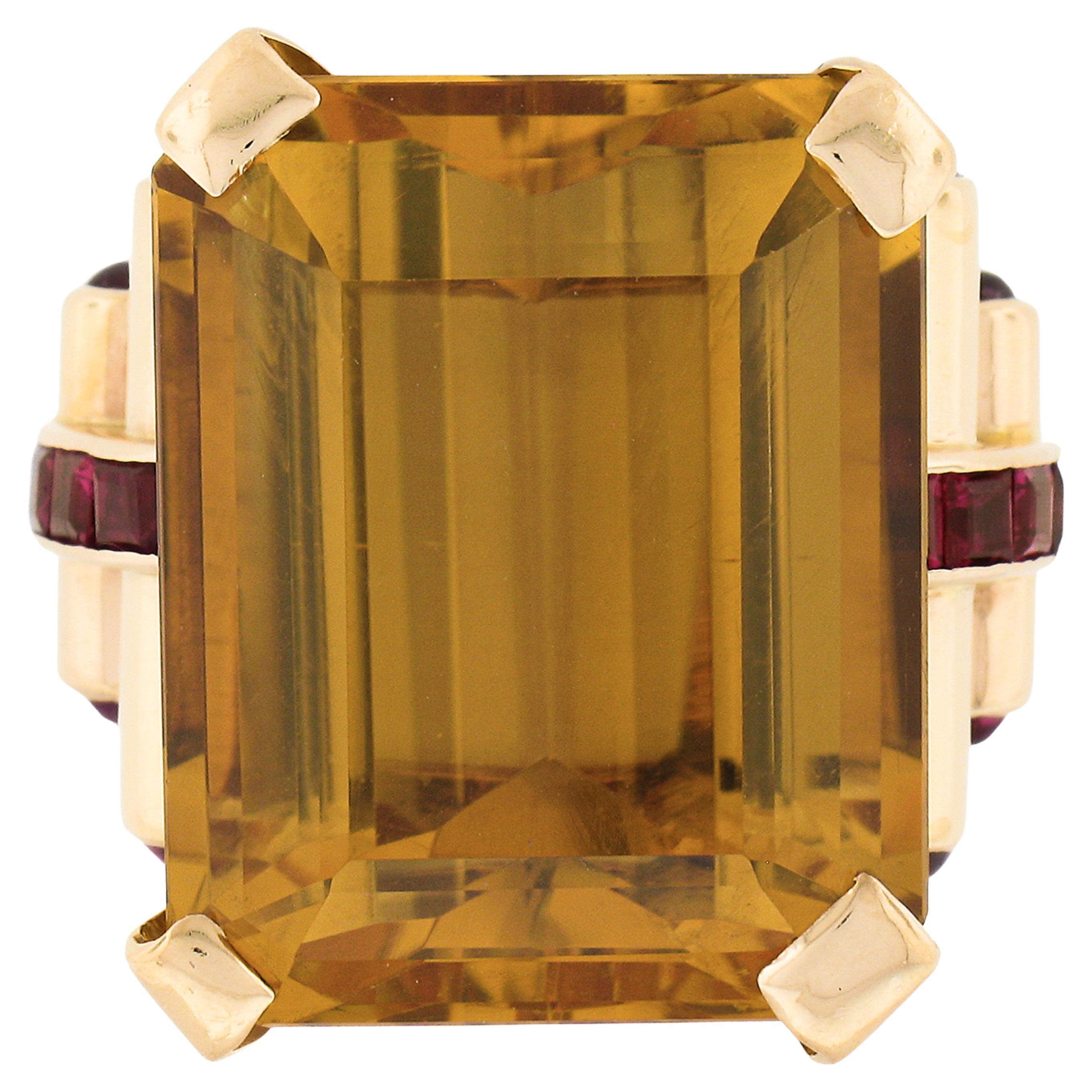 This magnificent vintage statement ring was crafted from solid 14k gold and carries a very large rectangular step cut citrine stone neatly prong set at the center of an open basket setting. The stunning solitaire has an incredible cutting style that