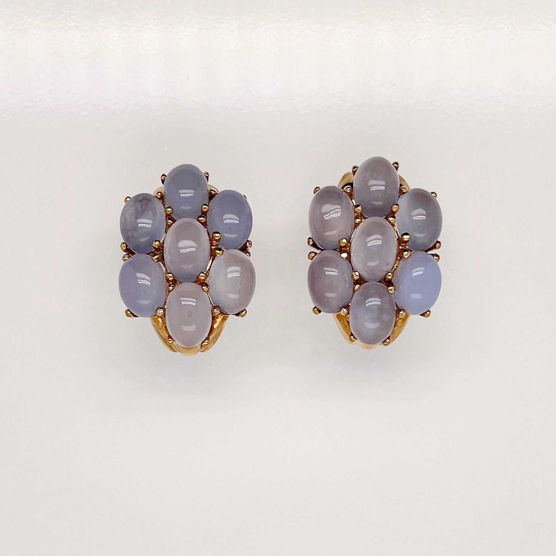 A very fine pair of gold & moonstone earrings.

Each prong set with light purple-blue moonstone cabochons in a stylized flower form 14k gold setting. 

Secured with omega clips for extra safety.

Simply wonderful earrings!

Date:
20th