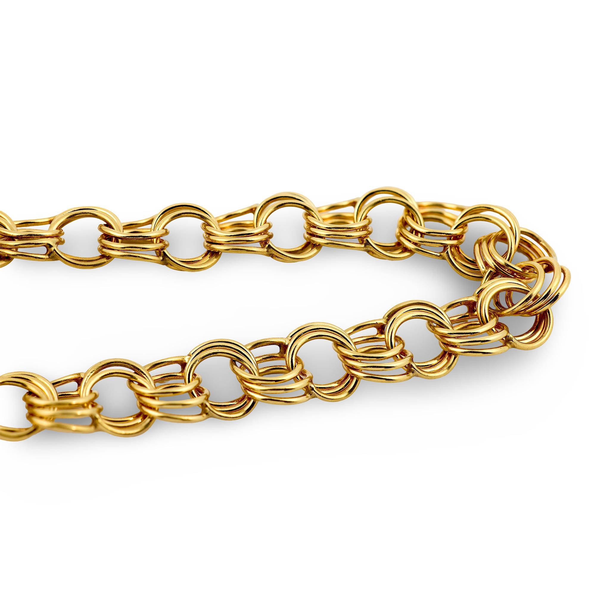 An absolutely exquisite bracelet from the Retro (ca1940s) era! Crafted in vibrant 14k yellow gold, this bracelet is comprised of interlocking circular-links. Each circular-link is tripled, which gives the piece a unique look! The bracelet is secured