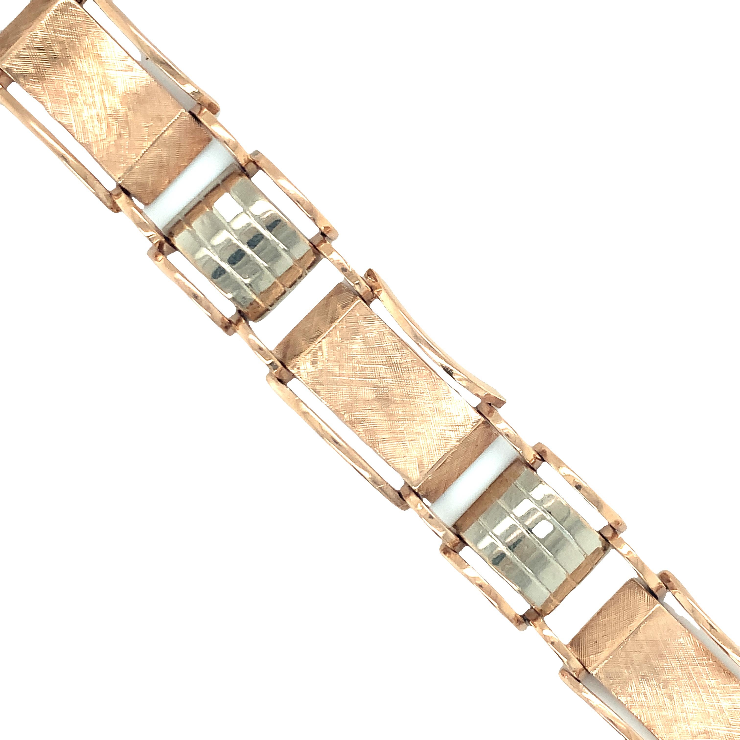 One Retro 14K rose and white gold link bracelet featuring textured and high polish finish links alternating throughout. Circa 1940s.

Chic, stackable, pretty.

Metal: 14K rose and white gold
Stamp/Hallmark: 14K
Size/Measurements: 7 inches