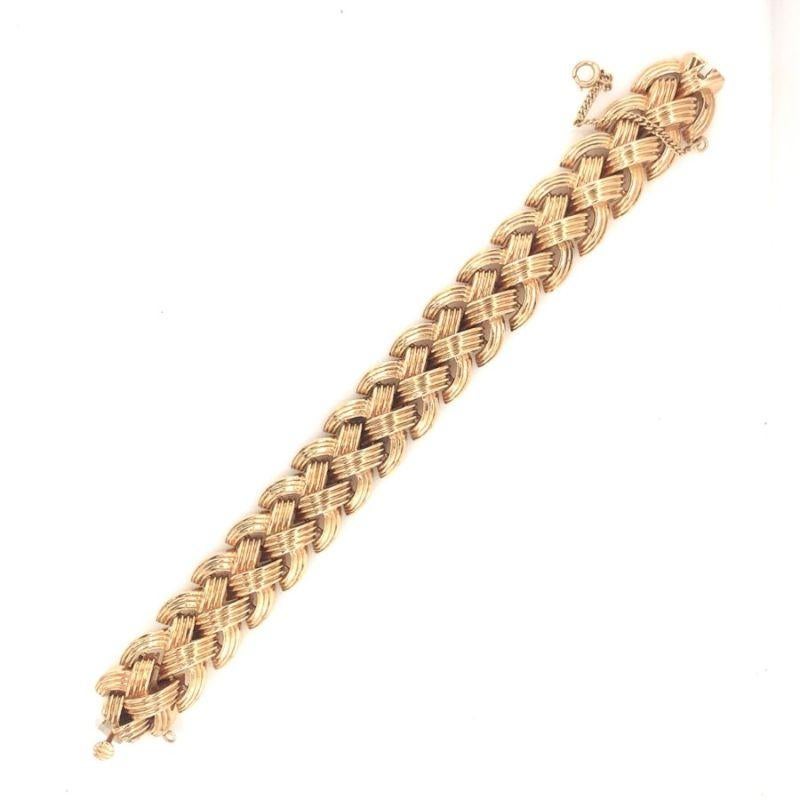 One Retro 14K rose gold bracelet with interlocking and raised ribbed gold finish links measuring 19 millimeters wide. Circa 1940s.

Powerful, heft, grand.

Additional information:
Metal: 14K rose gold
Circa: 1940s
Size/Measurements: 19 millimeters