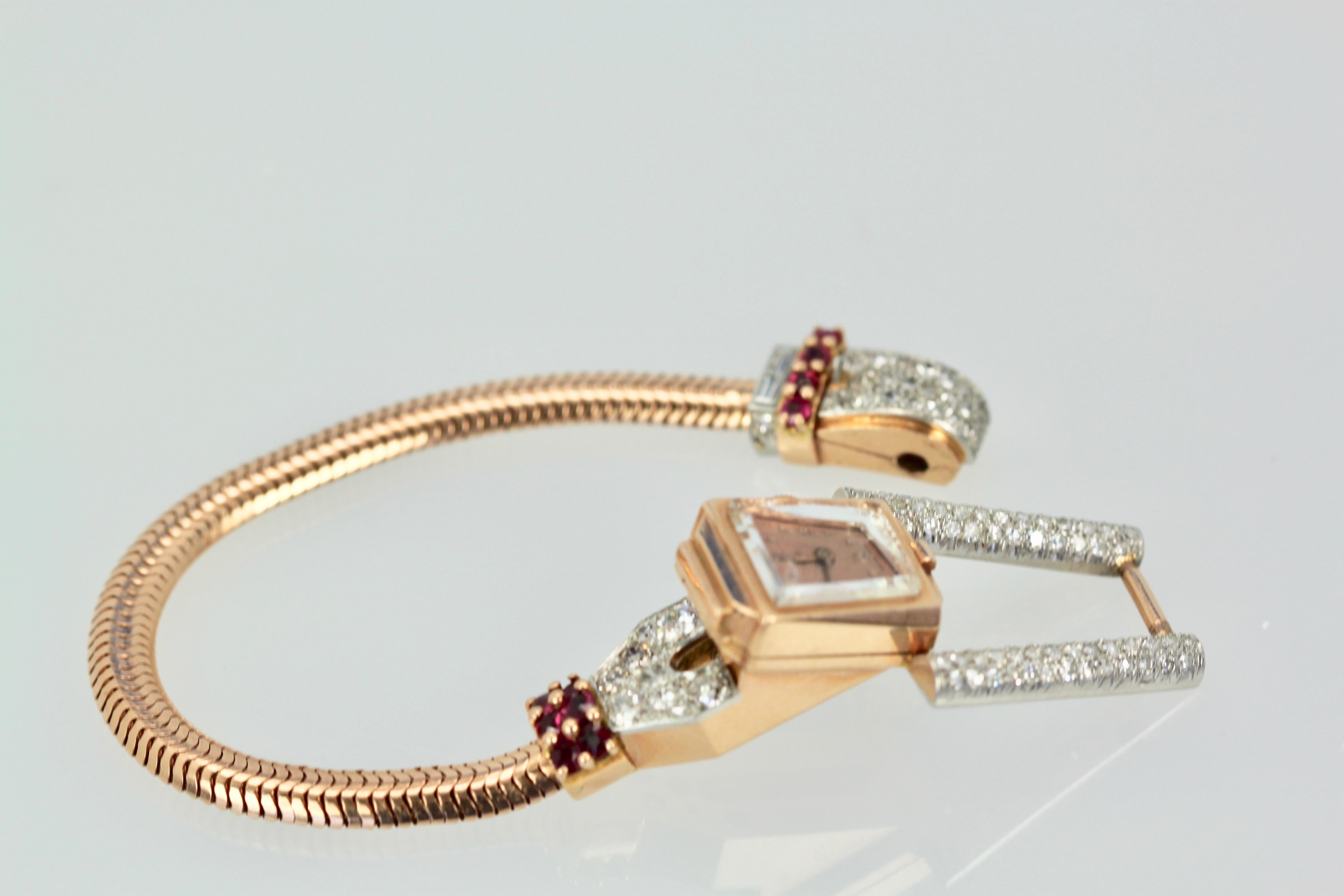 This gorgeous 14K retro watch is from the company Ciny and is from 1940. It has a snake bracelet in 14K Gold and is filled with Diamonds and Rubies.  The Diamonds are, VS G-H and there are one hundred and thirteen mixed cut Diamonds totaling 2.47