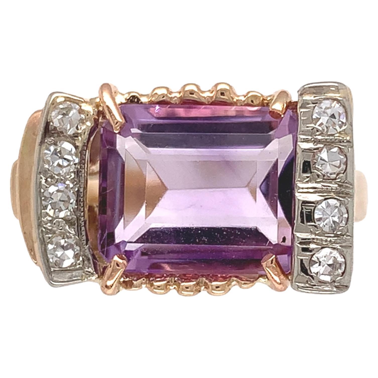 Retro 14K yellow gold amethyst and diamond ring. The ring features an emerald cu